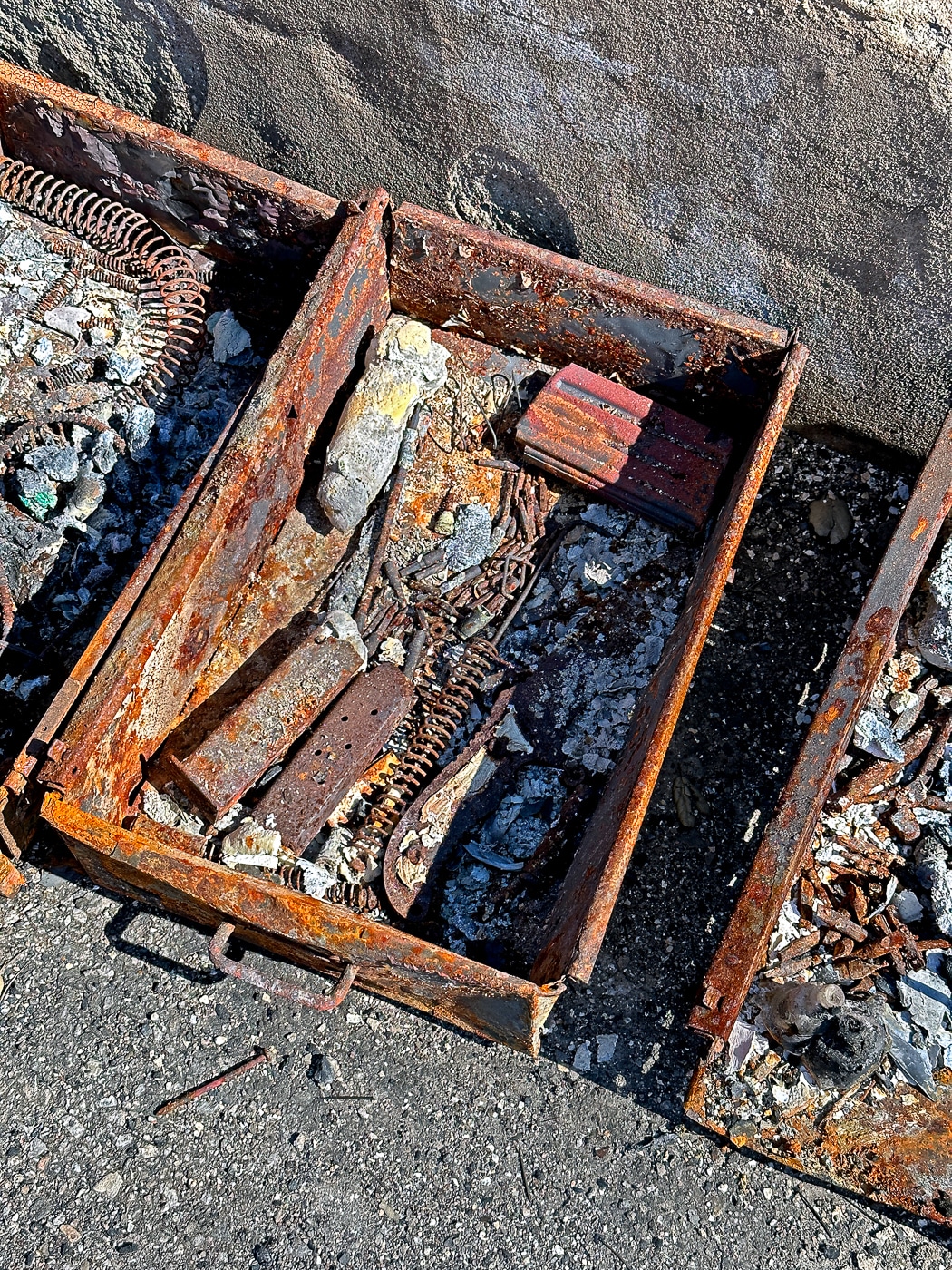 Interior of gun safe showing completely destroyed firearms and accessories after house fire demonstrating why insuring your guns with adequate coverage is essential regardless of security measures. Fire damage inside gun safes destroys rifles, pistols, shotguns, optics, ammunition, magazines, holsters, and any paper documentation stored with weapons making insurance claims the only recovery option. Gun owners must maintain comprehensive insurance policies when insuring firearms since even fire-rated safes have temperature and time limitations that fail during prolonged residential fires. Insurance adjusters need pre-fire photographic documentation of serial numbers and inventory spreadsheets since destroyed gun safe contents make post-fire identification impossible without prior records. Proper firearms insurance coverage accounts for total loss scenarios where safe interiors reach temperatures that melt weapons, destroy ammunition, and consume accessories requiring complete replacement through insurance payouts for gun collections.