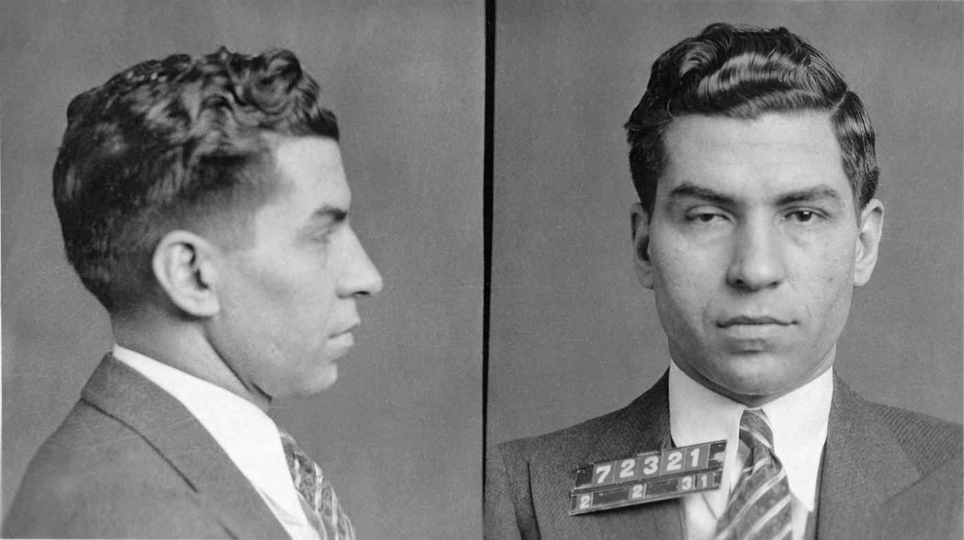 A 1931 police booking photograph shows Charles "Lucky" Luciano with identifying numbers, capturing the notorious mobster before his wartime collaboration. Operation Underworld utilized Luciano despite his criminal conviction and imprisonment. Mafia role in World War II centered on Luciano's waterfront connections. He maintained influence through trusted associates like Joseph Lanza. Criminal networks controlled longshoremen and port operations comprehensively. Luciano instructed subordinates to assist Naval Intelligence officers directly. His cooperation prevented labor strikes disrupting military shipments critically. Governor Thomas Dewey commuted Luciano's sentence for wartime contributions. The arrangement demonstrated pragmatic government decision-making during national crisis.