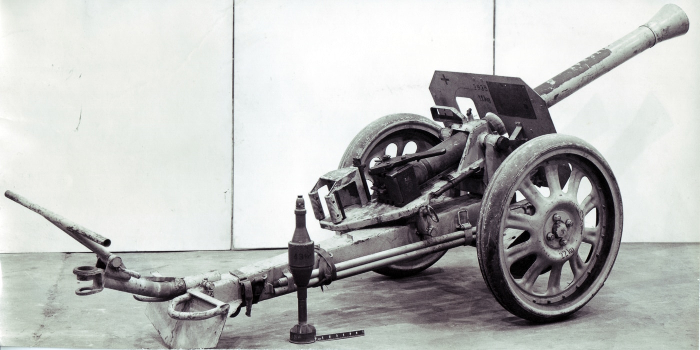 A preserved 8.8cm Raketenwerfer 43 Püppchen is shown in a static display with its distinctive small carriage and gun shield. The Raketenwerfer 43 was a German rocket launcher. Püppchen crews targeted Allied tanks. The weapon used RPzBGr 4312 rockets. This anti-tank launcher had a closed breech. German forces deployed the Püppchen in defensive positions. The carriage wheels could be removed for lower profile. Hollow charge warheads penetrated tank armor. Late-war German units relied on rocket weapons.