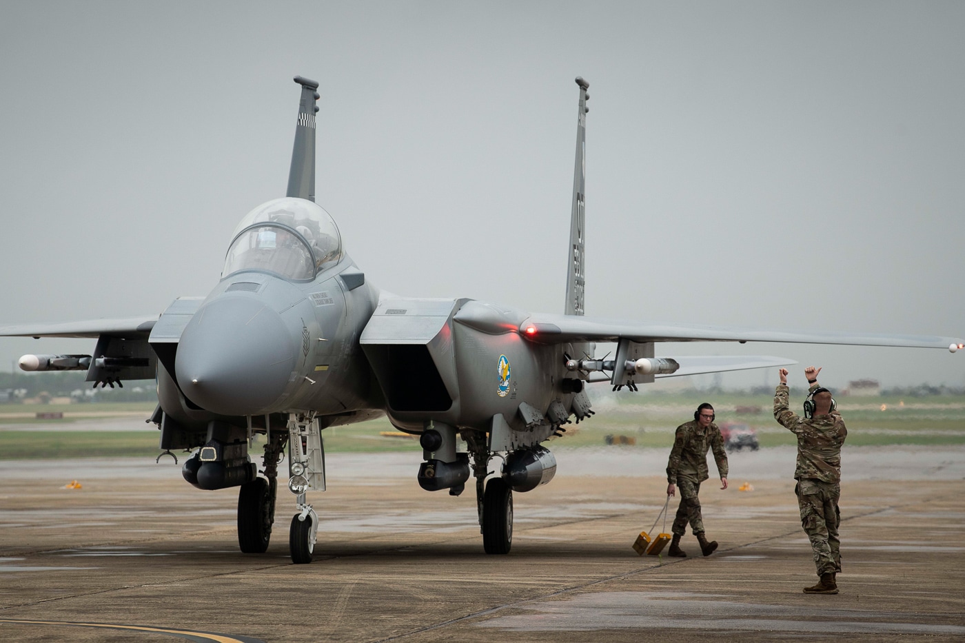 The F-15EX Eagle II taxis to parking at The Great Texas Airshow 2022, the twin-engine fighter drawing attention from crowds gathered at Joint Base San Antonio to see America's newest combat aircraft. The airshow featured cutting-edge military hardware. Visitors observed the Eagle II's distinctive profile. The F-15EX represented next-generation F-15 technology. Ground crews guided the fighter to display position. San Antonio hosted thousands of aviation enthusiasts. The modernized fighter highlighted Air Force investments. Public events introduce citizens to defense programs. The 2022 appearance preceded wider operational deployment.