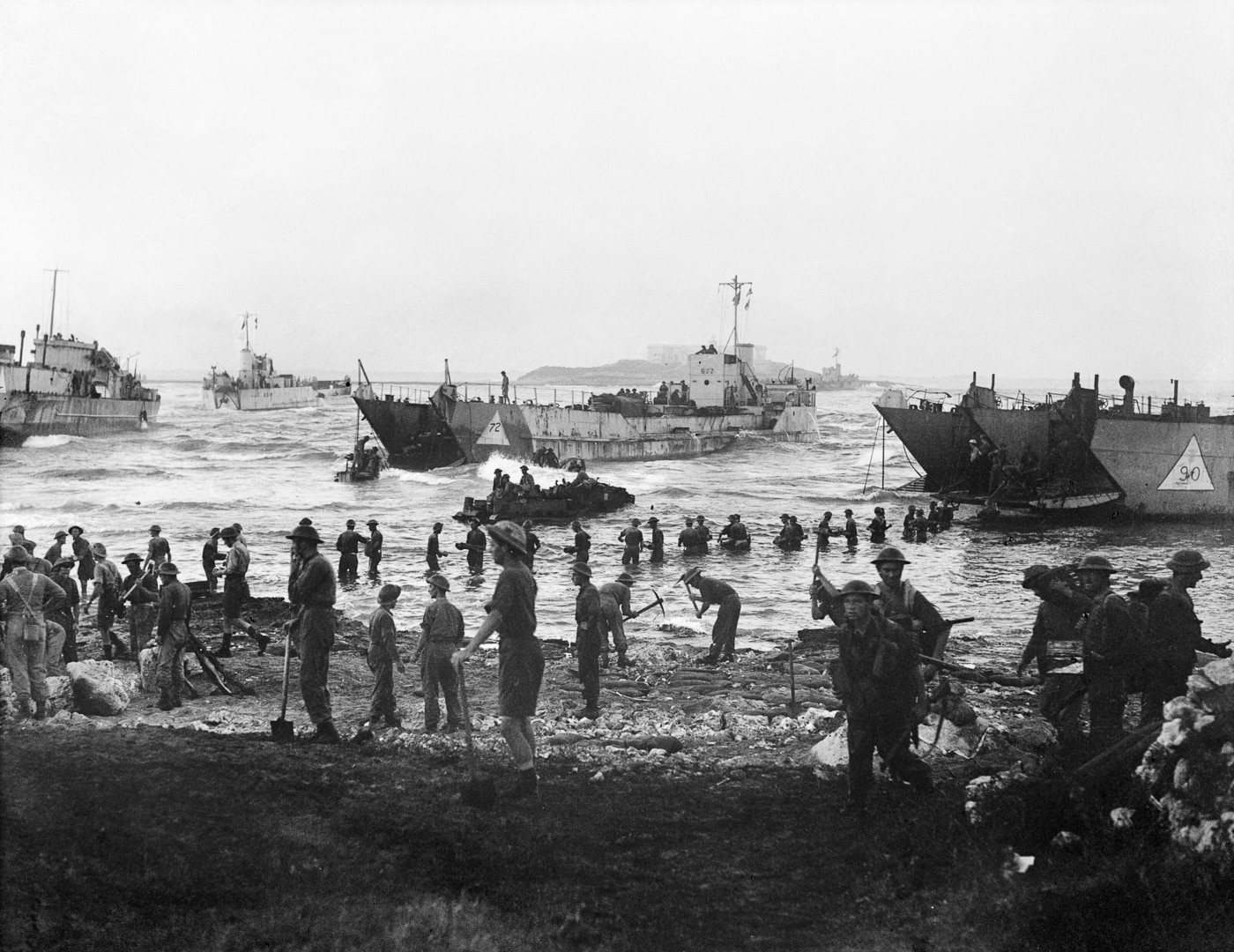 Scottish soldiers from the 51st Highland Division unload military supplies and equipment from a tank landing craft onto a Sicilian beach on July 10, 1943. Operation Underworld's influence extended to supporting this Mediterranean invasion directly. Mafia role in World War II included facilitating Allied military operations abroad. Sicilian mobsters provided crucial intelligence about German troop positions. Criminal networks helped soldiers avoid ambushes in unfamiliar territory. Lucky Luciano's connections enabled contact with local Mafia leaders. The collaboration ensured smoother transition from fascist to Allied control. Local guides identified enemy loyalists hiding among civilian populations. This unconventional alliance demonstrated strategic military value during critical operations.
