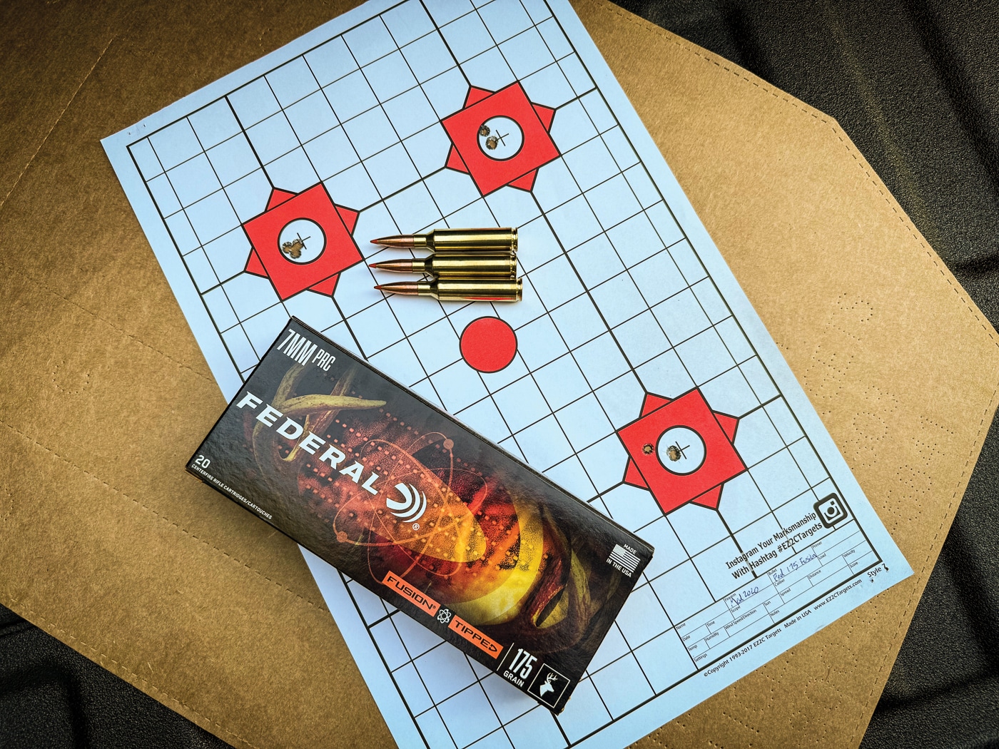 A shooting target displaying tight shot groups next to Federal Fusion Tipped 7mm PRC ammunition demonstrating exceptional accuracy from the Springfield Waypoint rifle. Federal Fusion Tipped 175-grain loads produced 0.58-inch best groups. The Model 2020 Waypoint achieved an average group size of 0.65 inches with Federal ammunition. Springfield's accuracy guarantee stands at 0.75 MOA for factory rifles. The 7mm PRC generates 2,880 fps with Federal's bonded bullet design. Polymer-tipped bonded projectiles ensure reliable expansion and weight retention. Multiple ammunition brands shoot accurately in quality rifle platforms. The 7mm PRC Model 2020 Waypoint performs consistently across ammunition types. Sub-MOA accuracy validates premium hunting rifle investments.