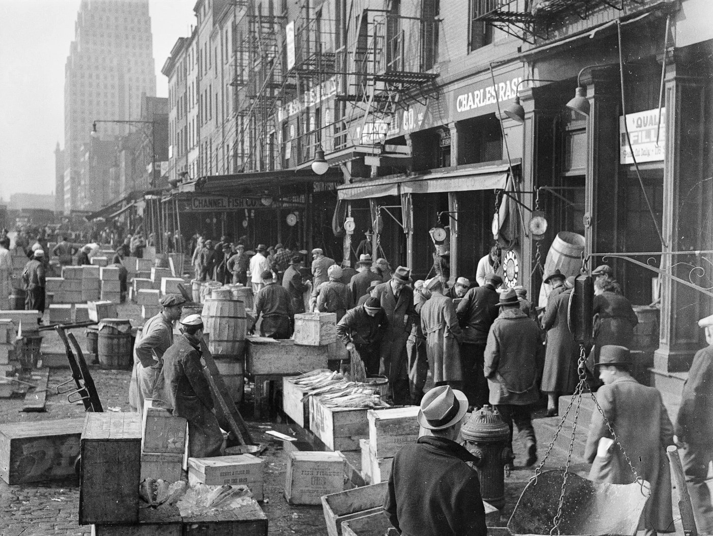 Fish vendors stand among wooden barrels and crates at the bustling Fulton Street Fish Market in 1937, the commercial hub that Joseph Lanza controlled. Operation Underworld utilized Lanza's strategic position within maritime commerce operations. Mafia role in World War II included monitoring activities at critical market facilities. Lanza held capo status in the Luciano crime family hierarchy. His control over United Seafood Workers union provided waterfront access. Criminal oversight prevented sabotage attempts at this busy commercial hub. Lanza enforced discipline maintaining order without excessive violence typically. The collaboration ensured smooth transit of military cargo shipments. His cooperation with Naval Intelligence deterred enemy agents effectively.