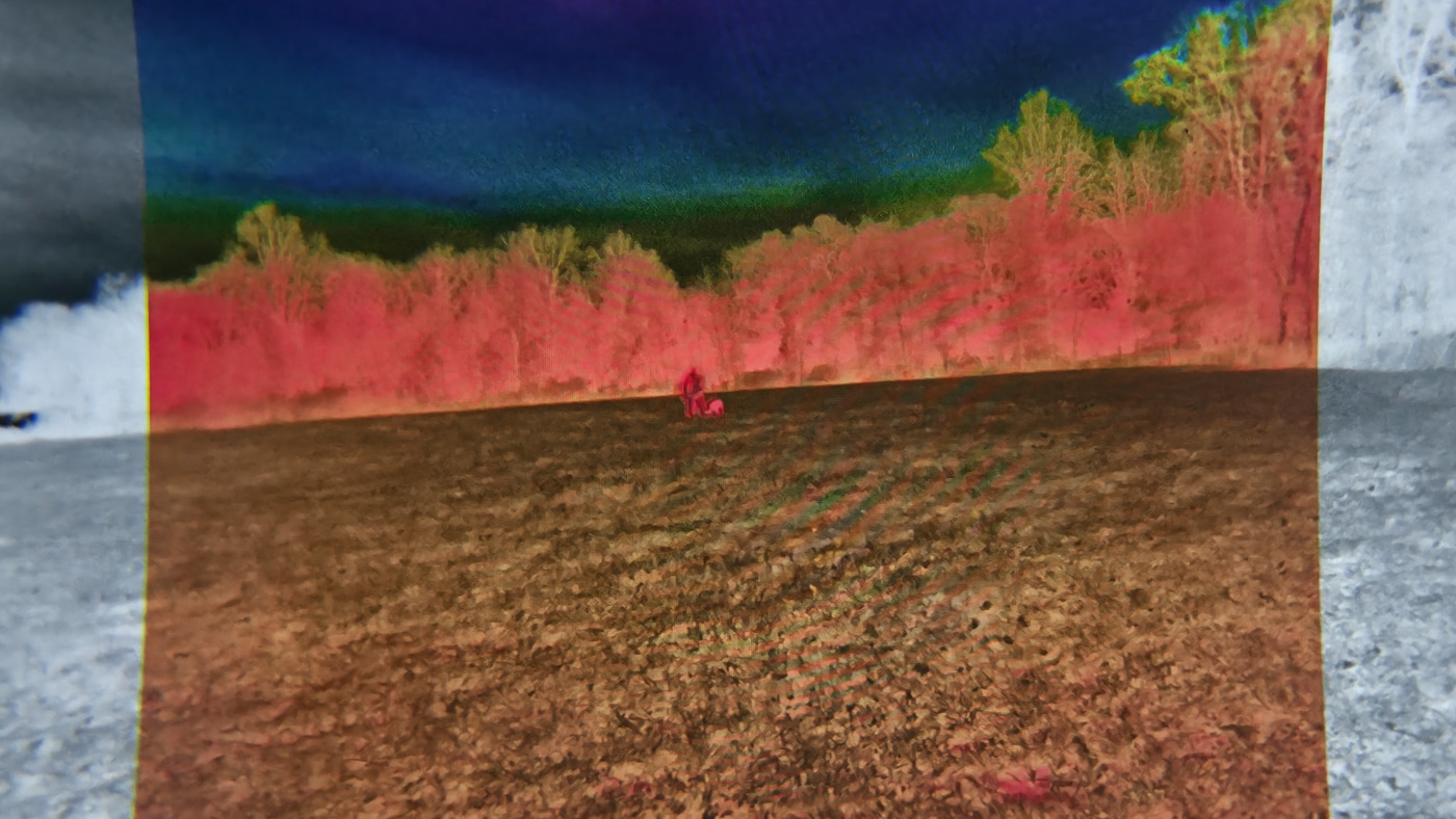 Display screen from Shinenyx G1A showing Fused Image Technology with thermal hotspots overlaid on detailed night vision imagery revealing both heat signatures and environmental context simultaneously. The Shinenyx G1A review emphasizes F.I.T. technology advantages extensively. Fused Image Technology combines dual sensor data. Thermal and night vision merge into single images. Shinenyx night vision gear provides true overlay capability. Detail recognition improves with fusion processing. Thermal contrast highlights warm signatures instantly. The G1A delivers revolutionary viewing experience. Enhanced detection surpasses single-mode performance significantly.