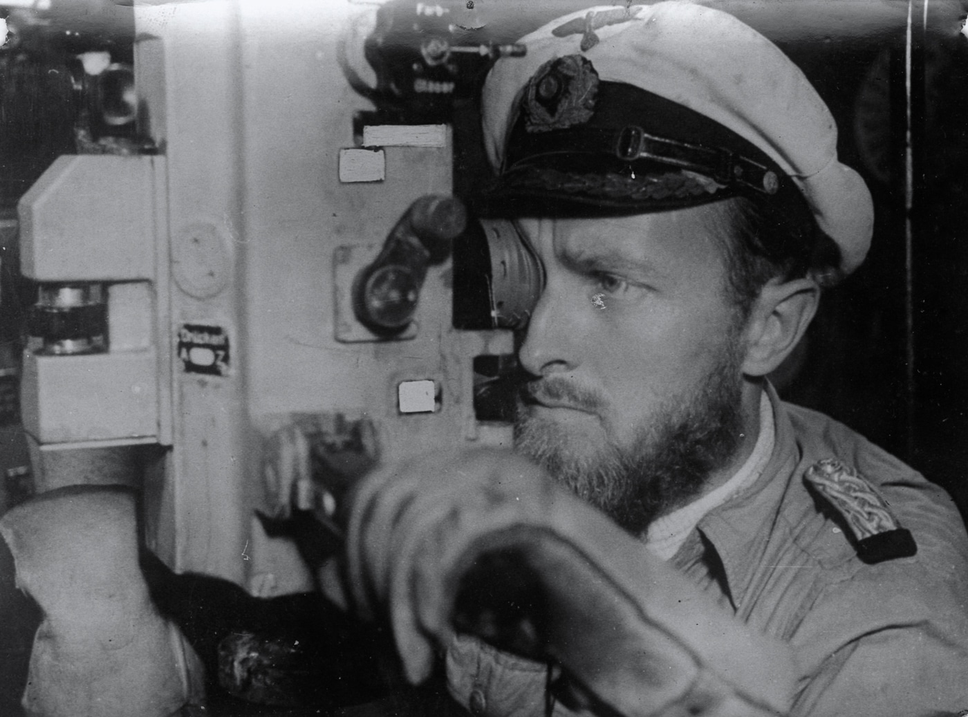 German U-boat captain peering through periscope