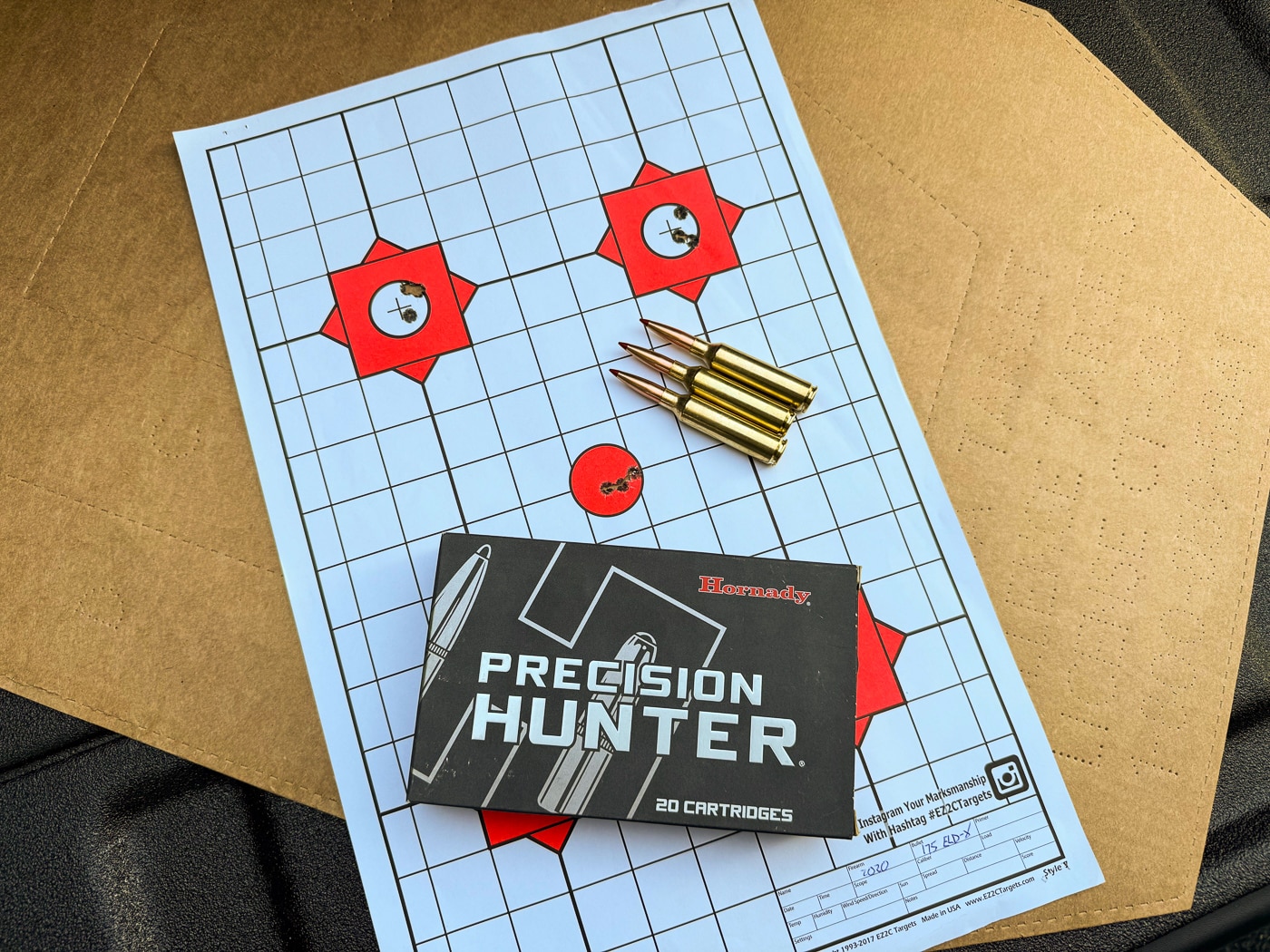 A target displaying tight shot groups alongside Hornady Precision Hunter 7mm PRC ammunition demonstrating the accuracy achieved with the Springfield Model 2020 Waypoint rifle. The Model 2020 Waypoint produces sub-MOA accuracy with factory ammunition. Hornady Precision Hunter 175-grain loads averaged 0.70-inch group sizes. Springfield guarantees 0.75 MOA accuracy from Waypoint rifles. The 7mm PRC cartridge delivers exceptional precision potential. Benchrest-quality groups prove rifle and ammunition combination effectiveness. The best three-shot group measured just 0.61 inches. The 7mm PRC Model 2020 Waypoint exceeds accuracy expectations. Quality factory ammunition eliminates handloading requirements for hunters.