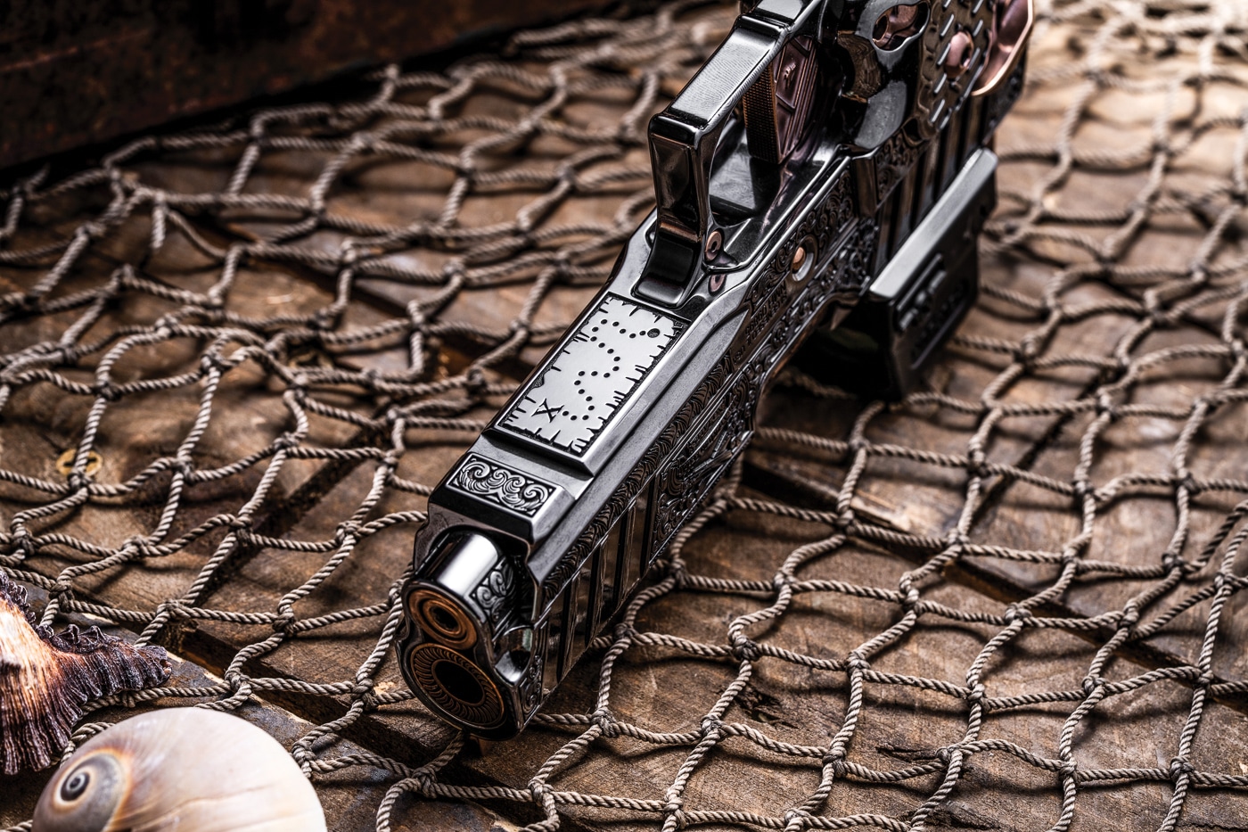 A detailed treasure map design is laser engraved onto the dust cover section of a customized Springfield 1911 DS Prodigy pistol frame. The Koted interview highlights intricate engraving capabilities. Koted Custom Finishings creates themed firearm builds. Interview of Koted discusses pirate-inspired custom projects. Laser engraving adds personalized storytelling elements. Koted interview reveals Easter egg design philosophy. Dust cover surfaces provide engraving canvas space. The interview of Koted covers creative risk-taking approaches. Koted maintains non-negotiable performance standards during customization.