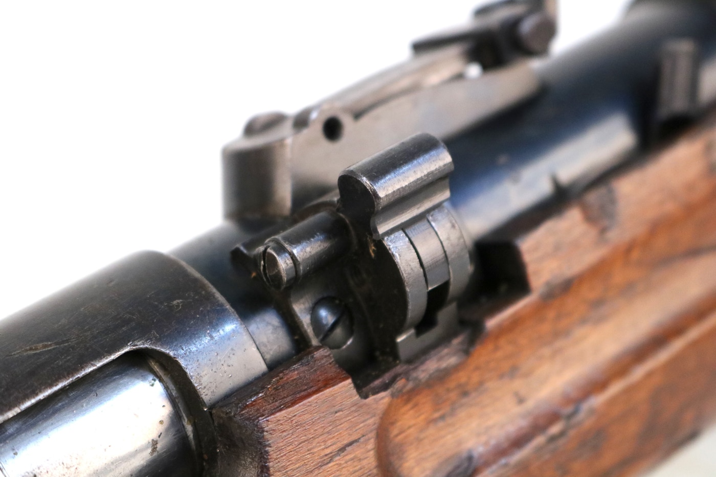 Early production MP35s came with this bizarre travel safety that locked the bolt either open or closed. Later versions ditched this feature entirely because it was complicated and probably unnecessary for combat troops who needed their weapons ready to go. A close-up photograph of the travel safety mechanism on an early-production Bergmann MP35, showing the lever and locking components that secured the bolt in either open or closed positions. MP35 travel safeties prevented accidental discharge. Bergmann engineers incorporated multiple safety features. The MP35 submachine gun included redundant safety mechanisms. German designers prioritized weapon security initially. SS troops used early MP35 variants sparingly. The Bergmann MP35 evolved throughout production. Waffen SS weapons reflected changing combat requirements. This safety feature disappeared from later models.