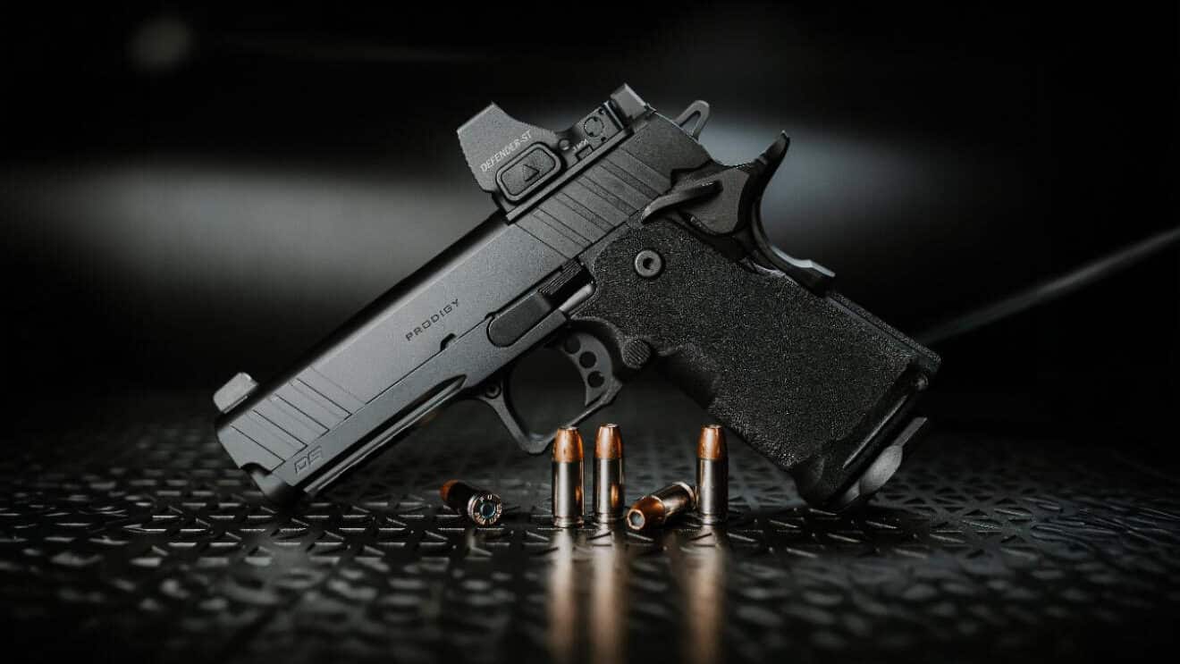 The Springfield Armory 1911 DS Prodigy Compact pistol displayed for a detailed review photograph. The Springfield Prodigy Compact review examines this modern double-stack handgun. This compact 9mm features a 4.25-inch bull barrel. The pistol includes an aluminum frame for reduced weight. Springfield designed the grip with aggressive stippling. The 1911 DS accepts 15-round flush-fit magazines. The Prodigy Compact serves multiple roles effectively. This handgun combines classic design with modern features. The compact frame suits everyday carry needs.