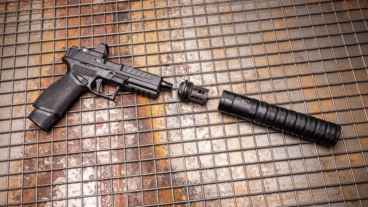 A side view image showing the Springfield Armory Echelon handgun equipped with the JK 155 HUB piston mount supporting the RPX 9mm suppressor at the muzzle. The JK Armament 155 RPX 9mm suppressor review covered pistol compatibility thoroughly. Spring-and-piston systems ensure proper slide cycling. The Echelon handles suppressed fire reliably. Duty pistols benefit from sound reduction greatly. The piston mount bundle includes necessary components. Suppressed shooting improves training communication. This modular silencer transitions between hosts easily. Tilting barrels require Nielsen devices for function.