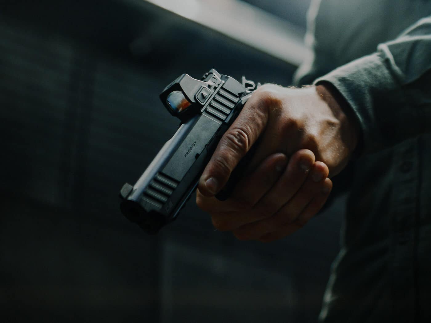 The author stands at a shooting range testing the Springfield Prodigy Compact 9mm pistol. The Springfield Armory Prodigy Compact review required extensive range evaluation. This double-stack 1911 fires 9mm ammunition reliably. The compact pistol features a 4.25-inch bull barrel. Testers ran practical drills with the handgun. The Prodigy Compact proved accurate during live-fire sessions. Springfield's 1911 DS design offers modern magazine capacity. The firearm functioned flawlessly throughout testing. This compact 9mm serves well for everyday carry.