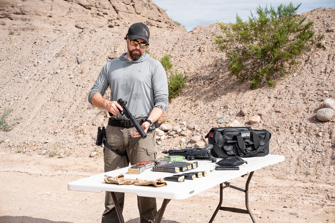 An image capturing the reviewer installing the JK Armament RPX 9mm suppressor onto his Springfield Armory Echelon handgun in preparation for live fire evaluation. The JK Armament 155 RPX 9mm suppressor review demonstrated pistol compatibility. Mounting a silencer requires correct thread engagement. The Echelon accepts the piston mount bundle easily. Suppressed pistols offer reduced noise signature. Shooters appreciate tool-free attachment methods. The Nielsen device ensures proper slide function. This modular suppressor works across multiple handguns. Quick installation encourages regular suppressor use.