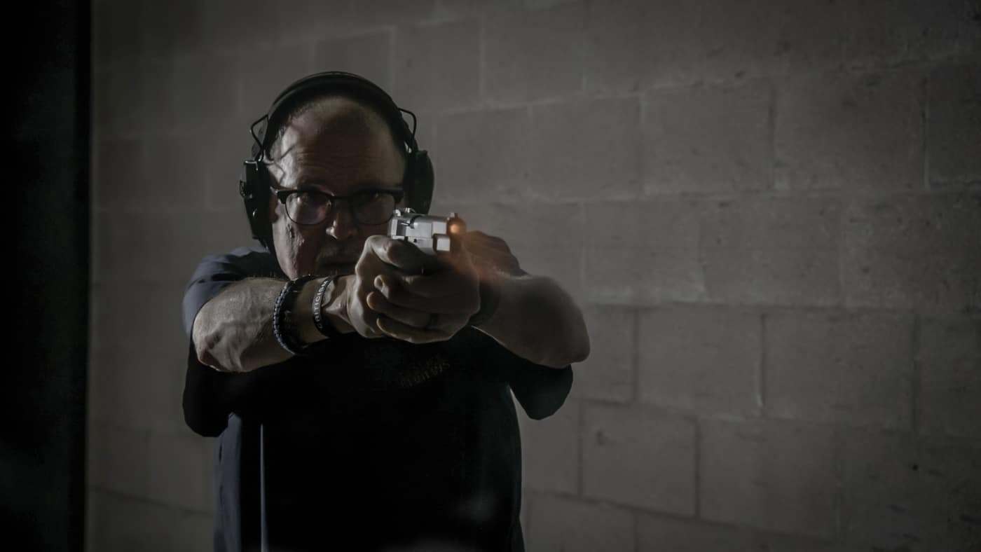 A shooter firing a Springfield SA-35 pistol equipped with XS Sights R3D 2.0 tritium night sights at an indoor range, demonstrating the practical application of the upgraded sight system during live-fire testing. Night sights for SA-35 perform during actual shooting. Tritium sights for Springfield SA-35 enable accurate engagement. Range testing validates sight performance. Self-defense pistols require real-world evaluation. XS R3D 2.0 sights support practical shooting. Live-fire testing demonstrates sight effectiveness. Quality sights improve shooting accuracy. Upgraded SA-35 pistols deliver reliable performance.