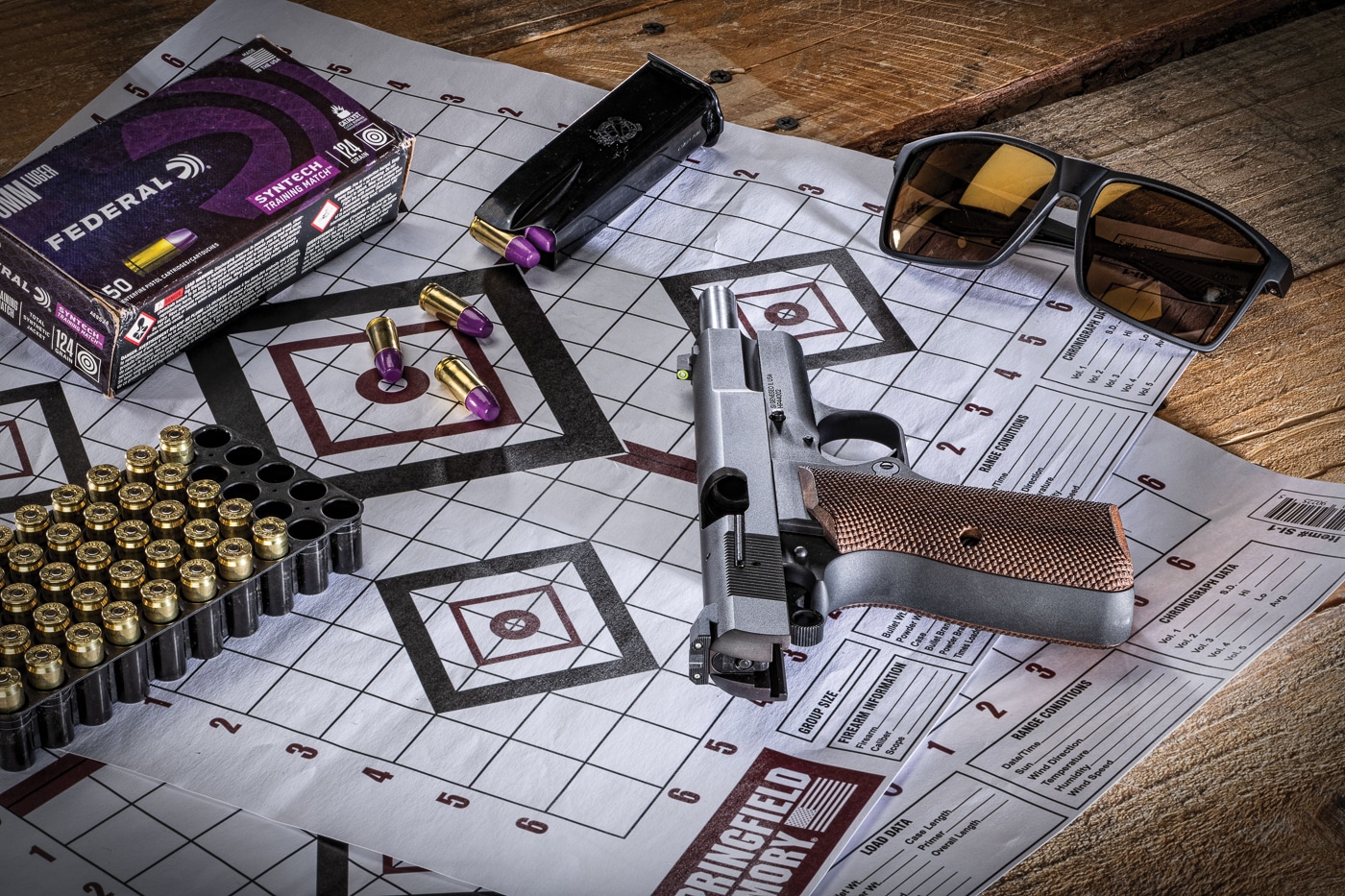 A Springfield SA-35 pistol equipped with XS Sights R3D 2.0 tritium night sights displayed alongside Federal Syntech Range ammunition boxes and paper shooting targets, showing the complete testing setup used for sight evaluation. Night sights for SA-35 require proper testing methodology. Tritium sights for Springfield SA-35 demand quality ammunition. SA-35 pistols perform with reliable cartridges. Self-defense sight testing needs consistent components. Federal ammunition supports accurate evaluation. Range testing requires appropriate targets. Quality gear ensures valid results. Premium sights deserve thorough assessment.