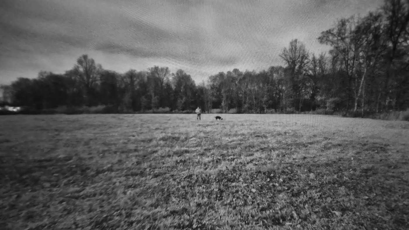 Display image from Shinenyx G1A in night vision-only mode showing a person standing with a dog clearly visible in green-tinted digital low-light view in outdoor field setting. The Shinenyx G1A review demonstrates pure NV performance capabilities. Night vision-only mode provides excellent clarity independently. Digital sensors detect subjects in low-light effectively. Shinenyx night vision gear features 1600x1200 CMOS technology. Visual identification includes fine details like animals. Low-light detection operates without artificial illumination. The G1A offers multiple viewing modes. Field testing confirms sensor quality exceeds expectations.