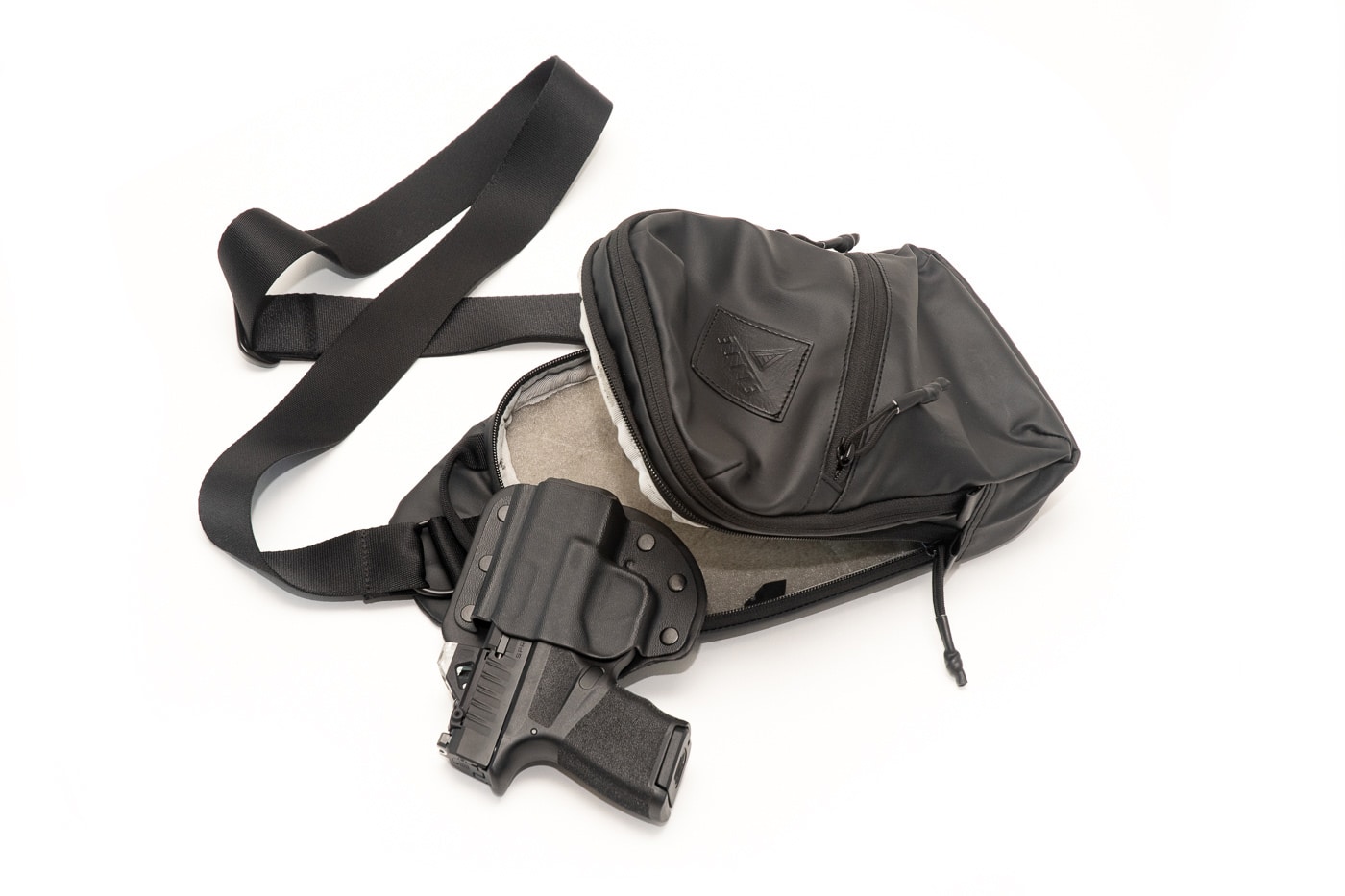An Elite Survival Systems tactical bag displays its concealed carry compartment design suitable for discreetly transporting a defensive pistol in workplace settings. Concealed carry at work utilizes off-body methods. Workplace CCW benefits from sling bags. Office carry demands secure bag storage. CCW at the office uses cross-body carriers. Professional concealment requires dedicated compartments. Business environments accommodate messenger bags. Concealed carry at work means constant bag control. Office defense includes tactical carry bags.
