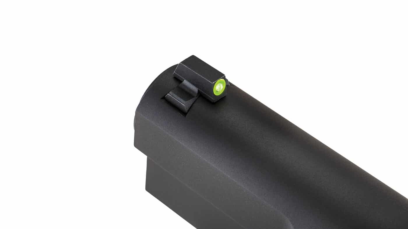 A close-up view of the XS Sights tritium front sight installed on a Springfield SA-35 pistol, showing the distinctive green photoluminescent glow dot surrounding the central tritium vial mounted in the front dovetail of the slide. Night sights for SA-35 feature dual illumination technology. Tritium sights for Springfield SA-35 include photoluminescent material. Front sight dots improve aiming speed. SA-35 pistols accept dovetail sight upgrades. Green tritium provides constant glow capability. High-contrast sights enhance target acquisition. Photoluminescent dots charge in ambient light. Quality front sights support defensive shooting.