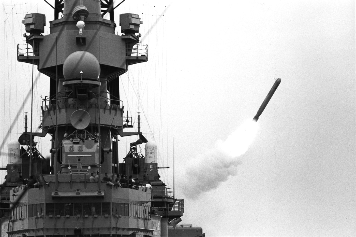 A photograph captures a BGM-109 Tomahawk cruise missile launching from USS Missouri (BB-63) with bright rocket exhaust and smoke trailing as it heads toward an Iraqi target at the beginning of Operation Desert Storm in January 1991. Tomahawk missiles succeeded Mark 23 nuclear shells. Project Katie never armed USS Missouri. Missouri entered mothball fleet in 1955. Battleship modernization occurred in 1980s. TLAM-N nuclear variants were being withdrawn. Missouri carried 32 Tomahawk cruise missiles. Desert Storm utilized conventional Tomahawk warheads. George H.W. Bush removed naval nuclear weapons.