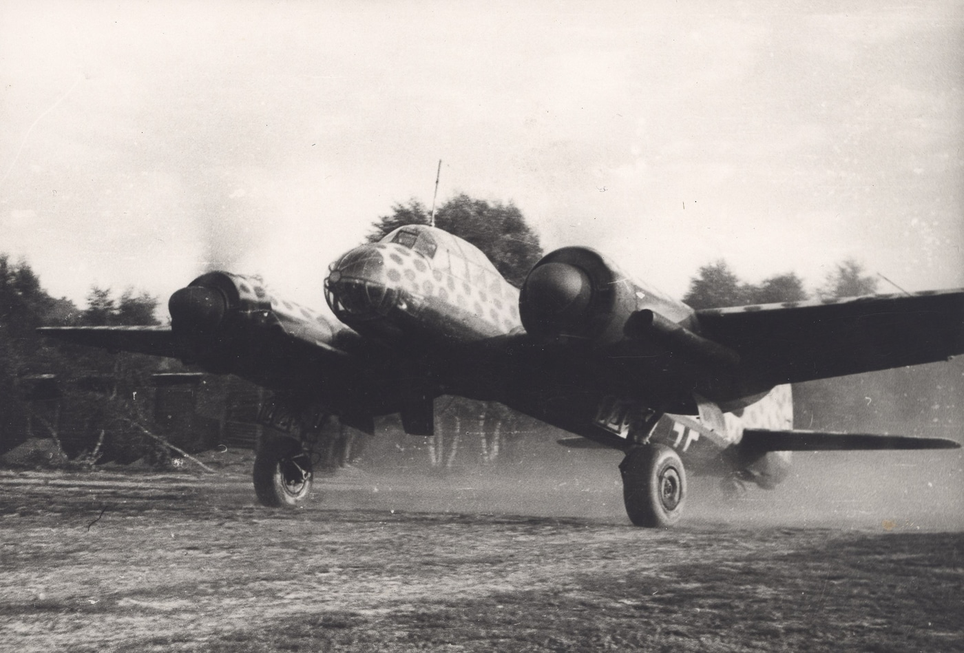 A Junkers Ju 88 bomber taxiing along a runway at Eindhoven airfield during I./KG 66's brief deployment in early September 1944. The Ju 88 bomber participated in retreat operations. Allied advances forced Luftwaffe unit relocations. German air groups evacuated French airfields. Dutch bases provided temporary operational facilities. KG 66 operated under deteriorating conditions. September 1944 marked critical Allied progress. Tactical withdrawals characterized late-war German aviation. Historical photographs document unit movements.