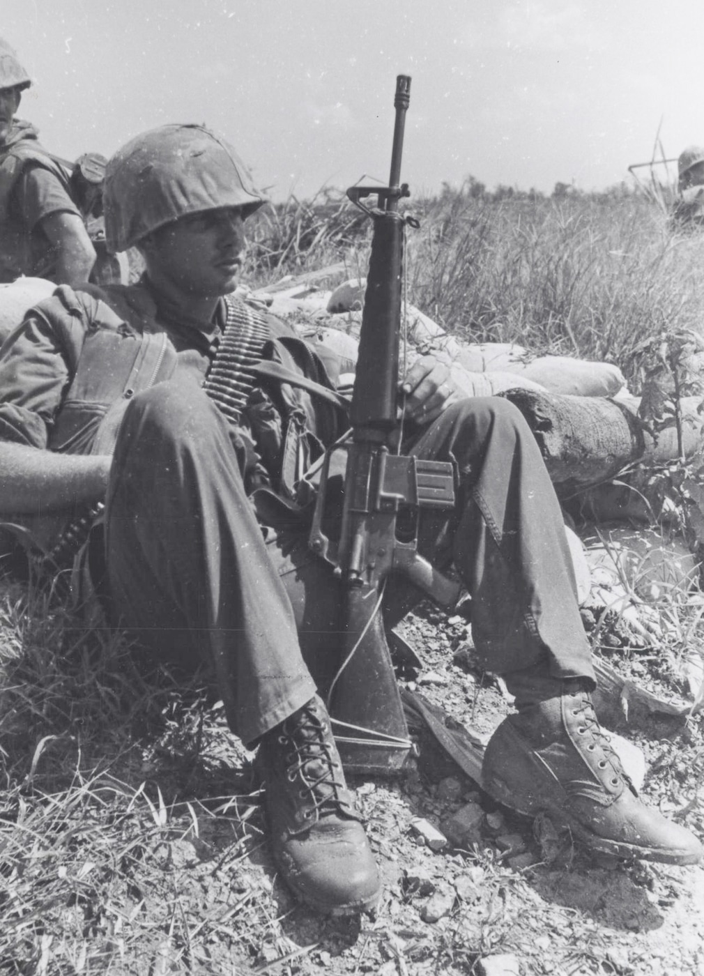 Lance Cpl Clements rests with M16A1 after a patrol through flooded rice patties south of Da Nang USMC