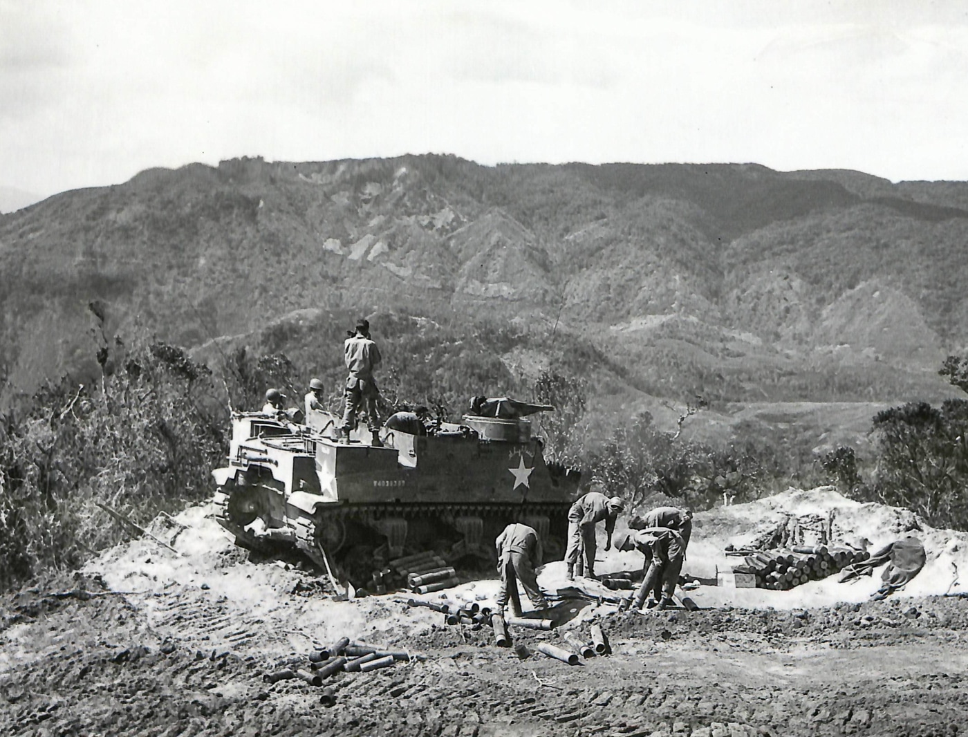 M7 crew on a hilltop firing on Japanese troops during liberation of Philippines