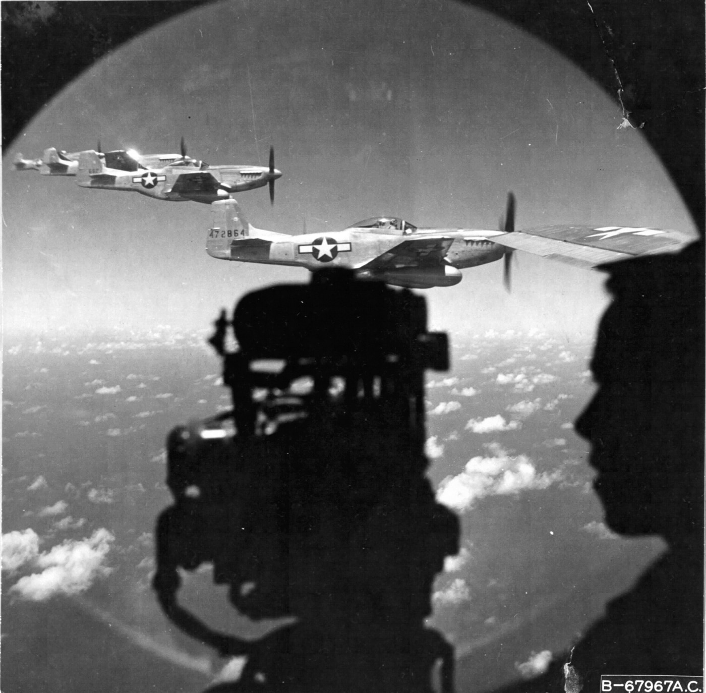 P-51 Mustangs seen from the side gunner blister of B-29