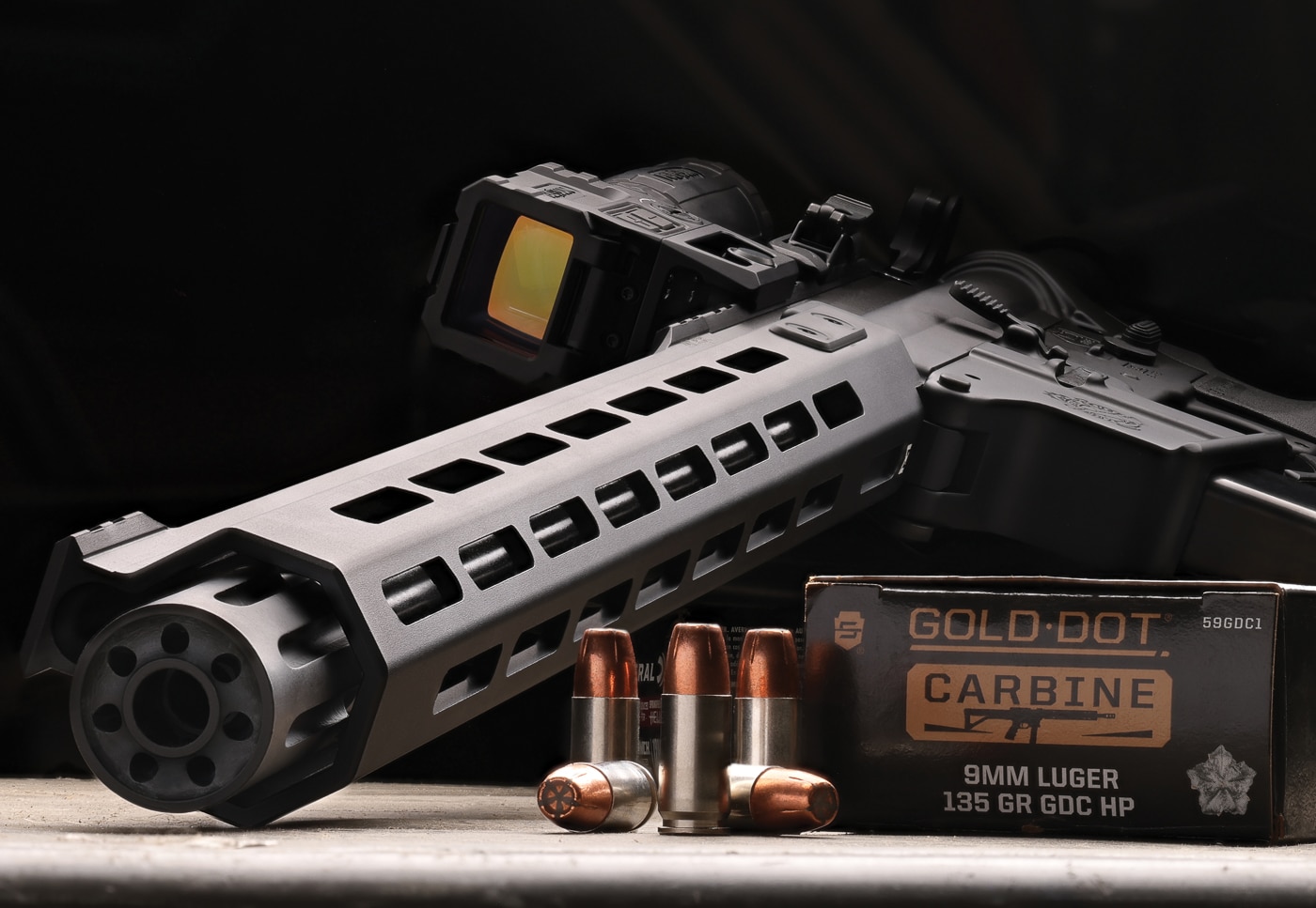 Several rounds of Speer Gold Dot Carbine 9mm ammunition are arranged showing the nickel-plated cases and hollow-point bullets. Speer Gold Dot Carbine ammunition features bonded bullet construction. PCC ammo utilizes heavier projectiles than standard loads. The 135-grain bullet weight optimizes carbine performance. Gold Dot bullets expand to nearly 64 percent larger diameter. Pistol caliber carbines generate higher velocities than handguns. The Speer Gold Dot Carbine review demonstrates consistent accuracy. Carbine ammunition uses sealed primers for reliable ignition. 9x19 Parabellum remains popular for defensive applications.