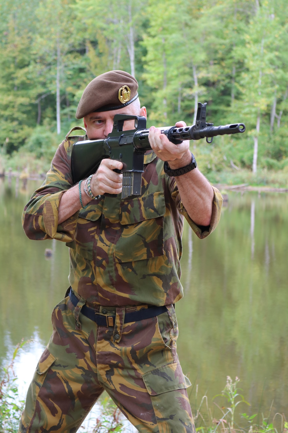 A shooter at an outdoor range firing a historic AR-10 rifle, demonstrating the practical function of Eugene Stoner's revolutionary 1950s battle rifle design. AR-10s remain highly shootable. The platform offers excellent accuracy. Stoner prioritized ergonomic design. AR10 history includes combat use. Original AR-10s still function. The rifle features manageable recoil. Portuguese troops praised AR-10s. Collectors value authentic examples.