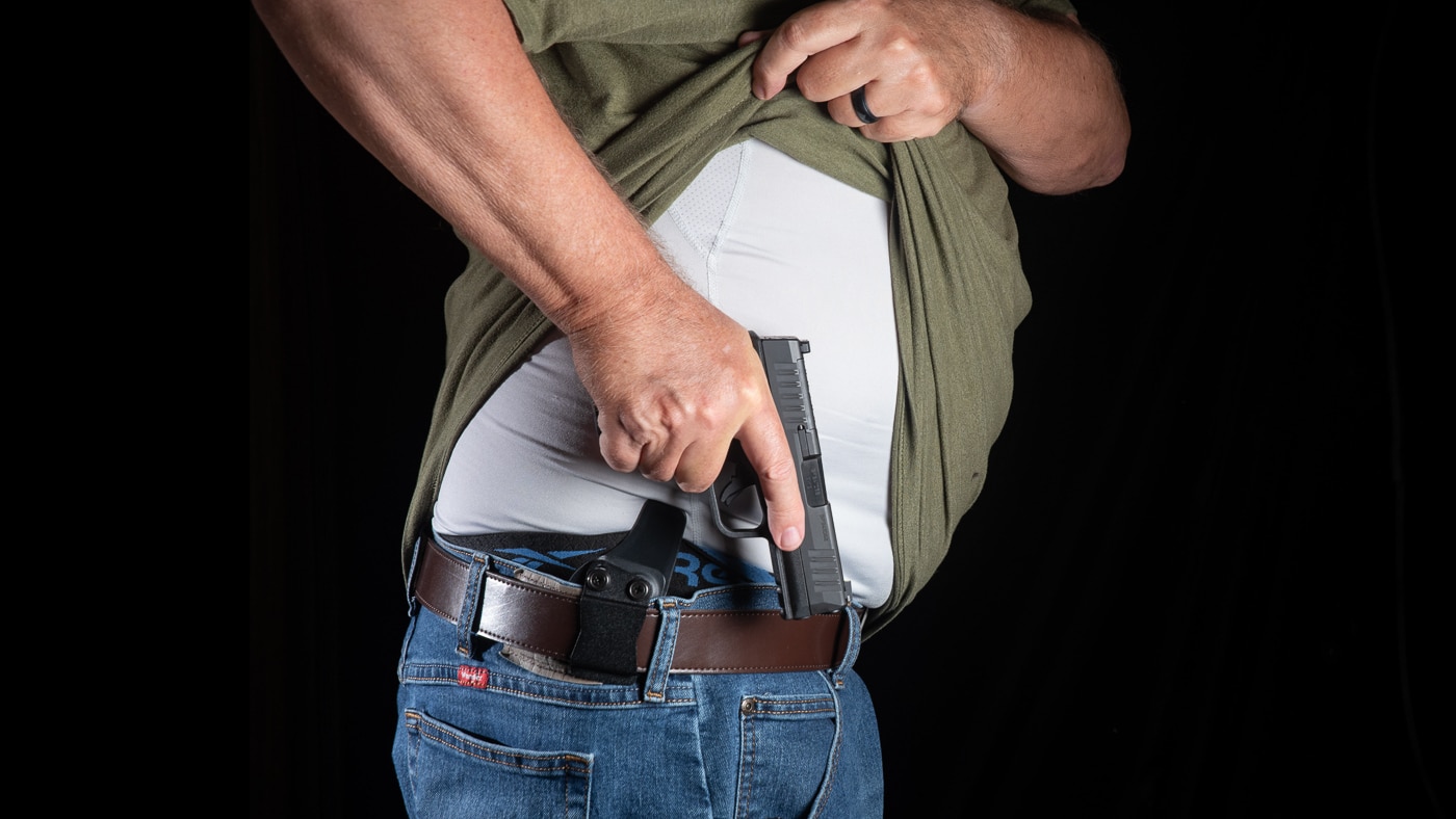 author drawing a pistol from concealment