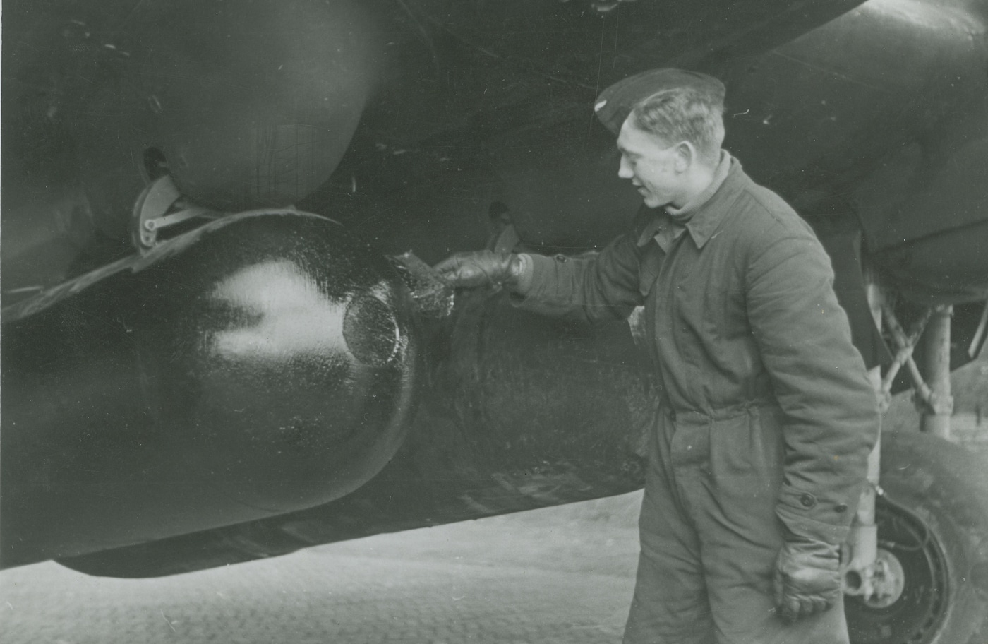 groundcrew checking a Luftmine B under a Heinkel He 111 of KG 4
