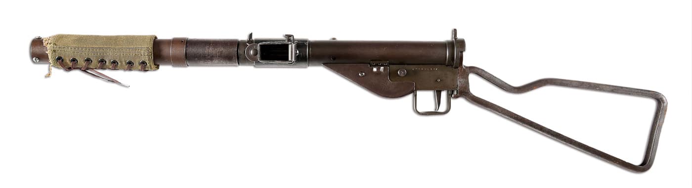 Full-length photograph of the silenced Sten Mk IIS displaying the characteristic canvas-wrapped suppressor, skeletal stock, and left-feeding magazine that made this 9mm submachine gun distinctive among WWII weapons. Silenced Sten Mk IIS revolutionized special operations.