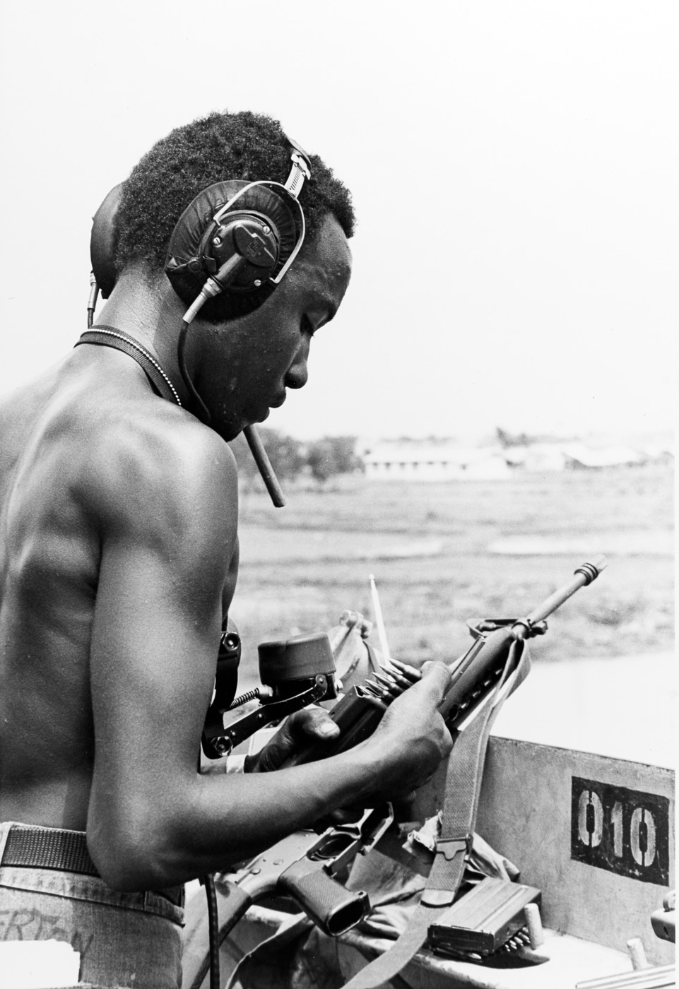 sailor loads M16 magazines on USS Harnett County on Vàm Cỏ Đông River Vietnam War