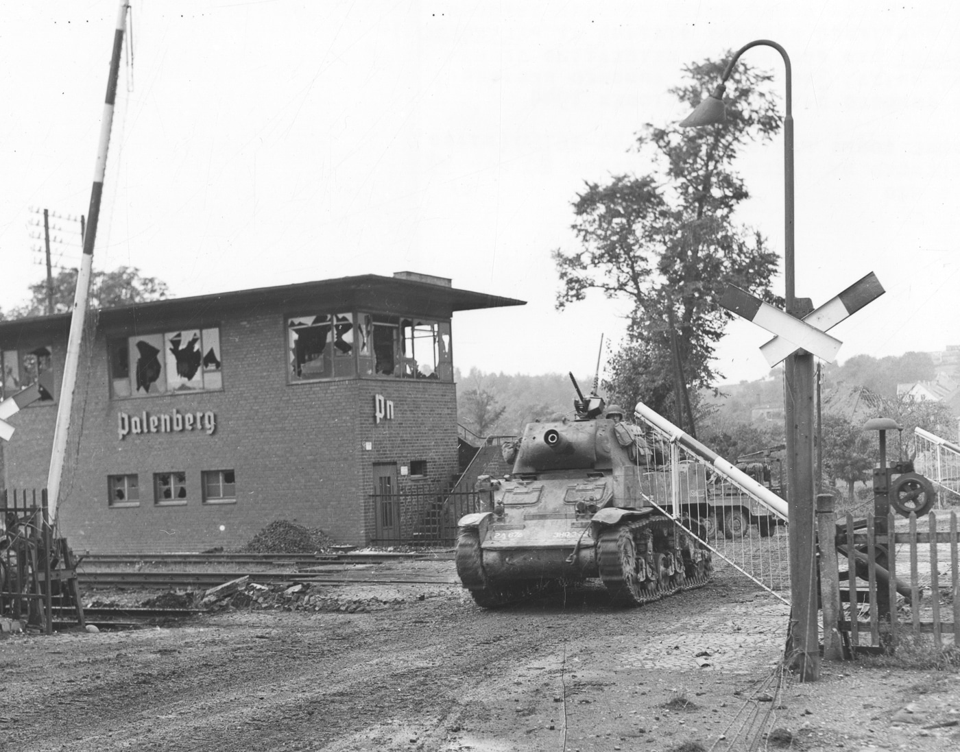 American M8 howitzer motor carriage moves through the railway station at Übach-Palenberg Germany in October 1944
