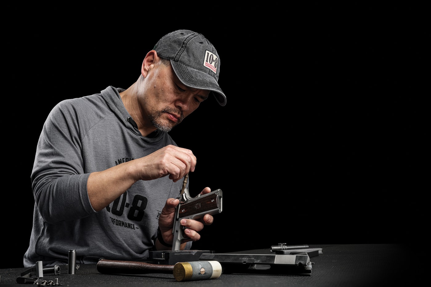 Hilton Yam working on a 1911 pistol