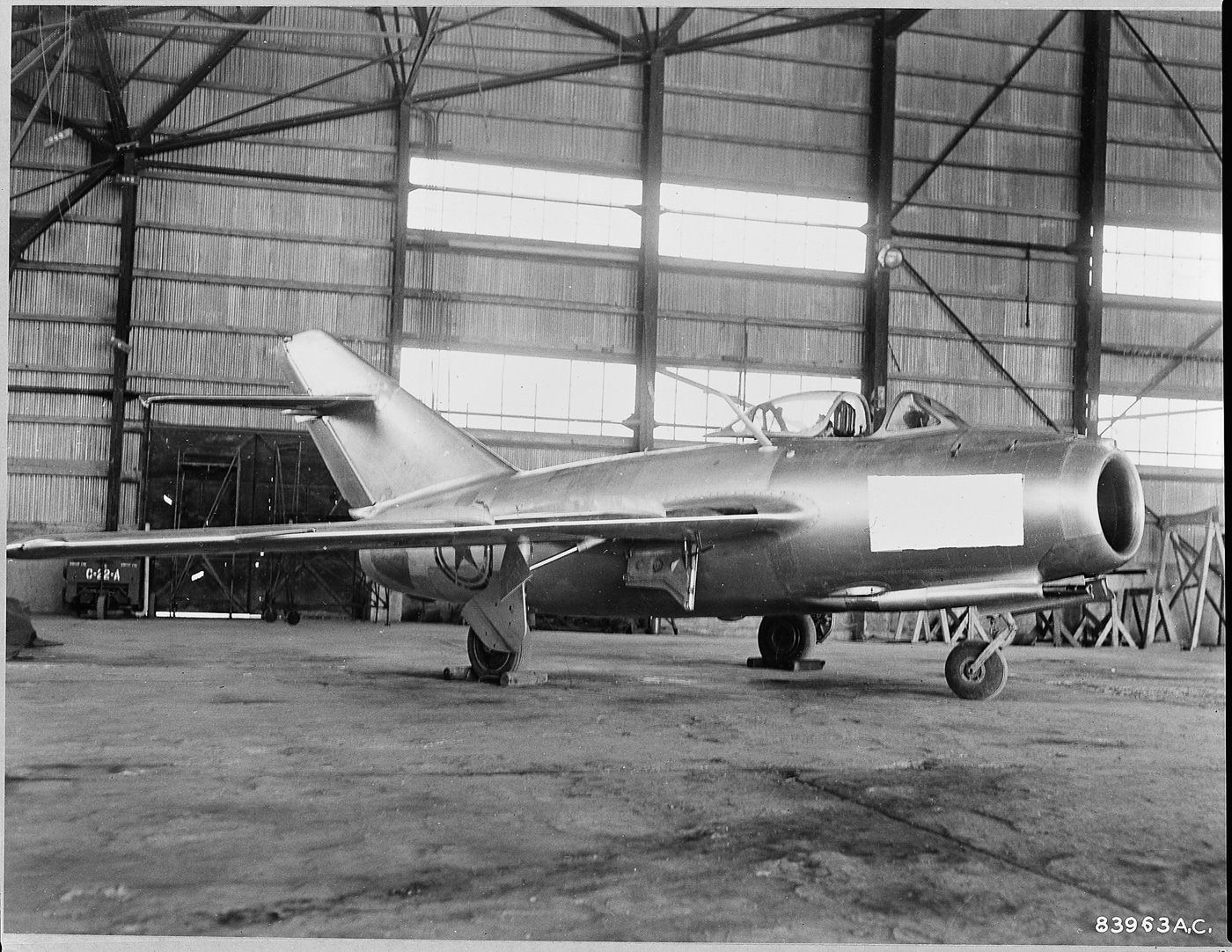 A Russian-built MiG-15bis fighter aircraft on static display, featuring the distinctive swept wings and nose intake that characterized this Cold War-era jet. The Mikoyan-Gurevich MiG-15 represented advanced Soviet engineering. North Korean pilot No Kum-Sok defected in 1953. The MiG-15 revealed communist aircraft capabilities. American engineers studied captured Soviet fighters. The Mig-15 underwent extensive flight testing. Defecting pilots provided valuable intelligence. Cold War defections altered technological understanding. Soviet aircraft secrets became Western knowledge.