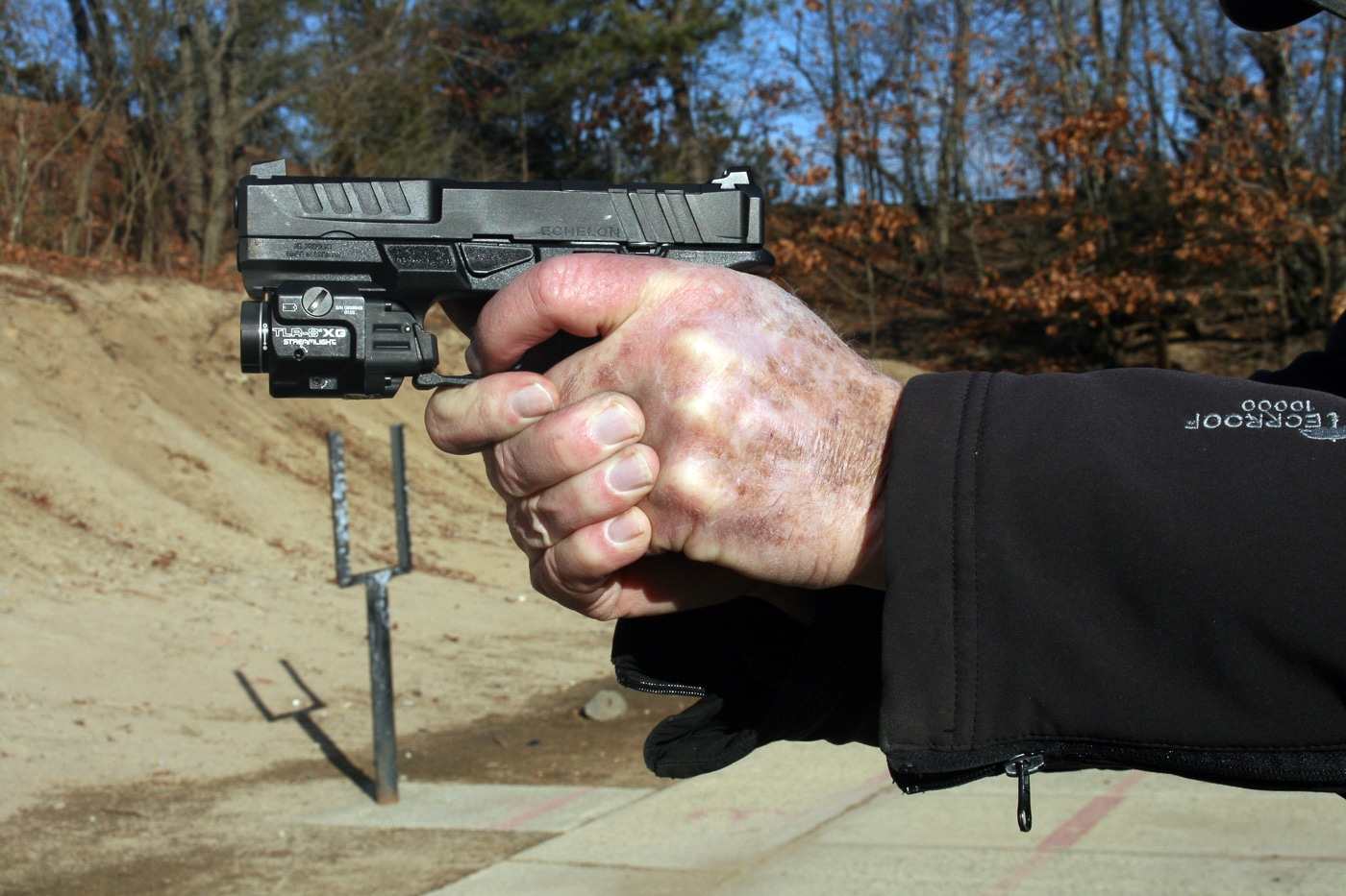A shooting instructor demonstrates proper trigger finger placement and reset technique while maintaining pistol control during live fire. Trigger reset mastery improves shooting speed. Efficient finger movement reduces split times. Tactile reset awareness enhances cadence.
