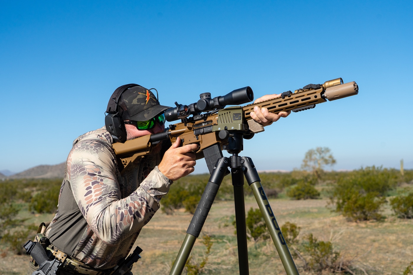 author shooting the rifle from a tripod during testing