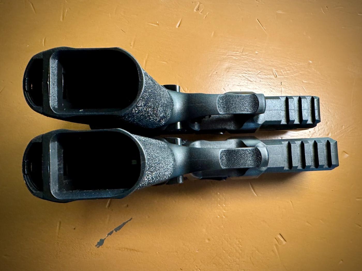 Side-by-side comparison shows the Echelon 4.0FC on top with its compact slide versus the full-size 4.5F below. That half-inch difference might not seem like much, but it can make a significant impact on holster clearance and how the pistol rides, especially for appendix carry.