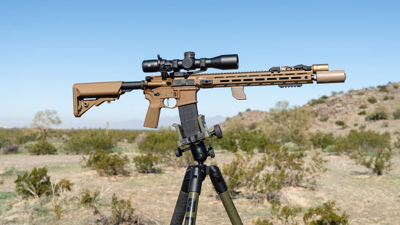 suppressor mounted on SAINT rifle that is attached to a tripod for accurate shooting