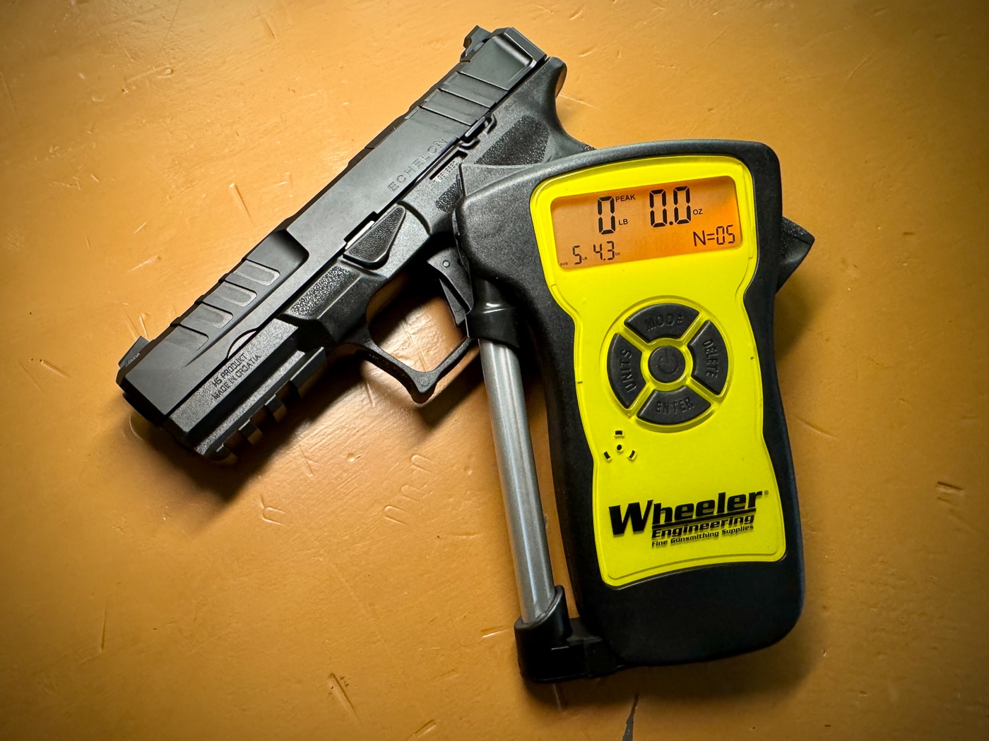 Close-up photograph shows the trigger mechanism and trigger guard area of the Springfield Echelon 4.0FC pistol emphasizing the flat-faced trigger design. Springfield Echelon 4.0FC review evaluates trigger performance. Springfield Armory Echelon 4.0FC testing measures pull weight. Trigger averages 5.43 pounds. Clean take-up precedes wall. Consistent pressure produces break. Positive reset pushes finger. Tactile click indicates readiness. Audible feedback confirms reset.