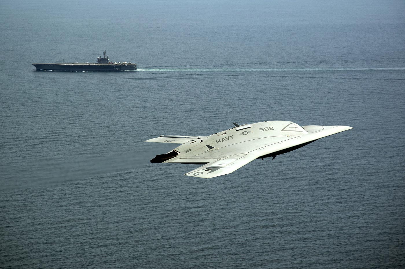 Northrop Grumman X-47B in flight above USS Harry S Truman CVN-75