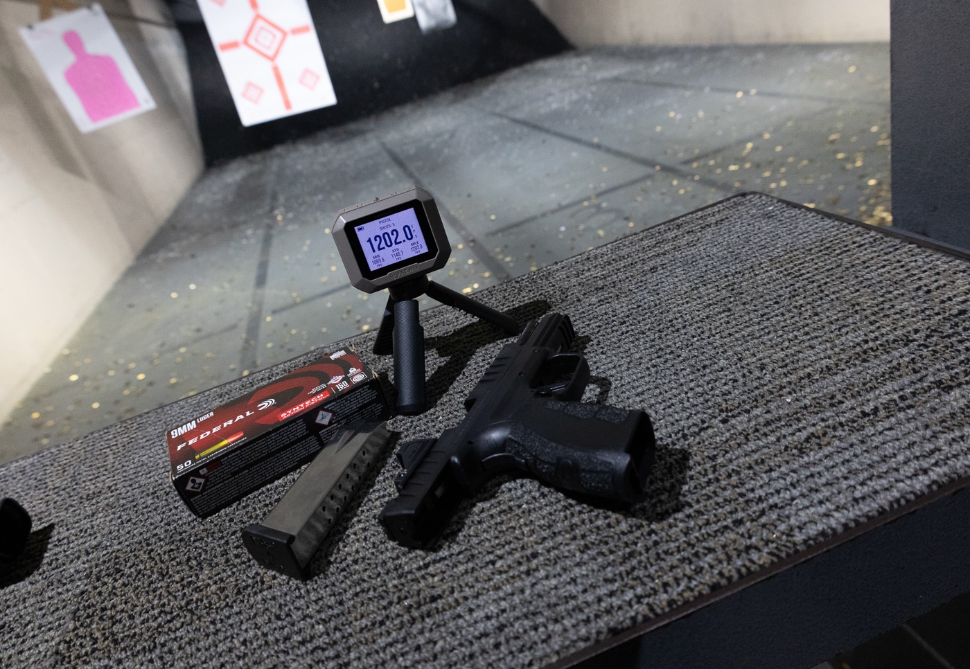Springfield XD Mod.4 with chronograph and ammunition at the range