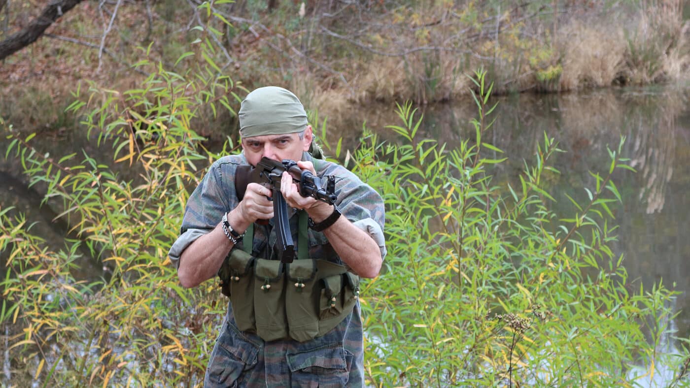 author firing AK-47 on outdoor range
