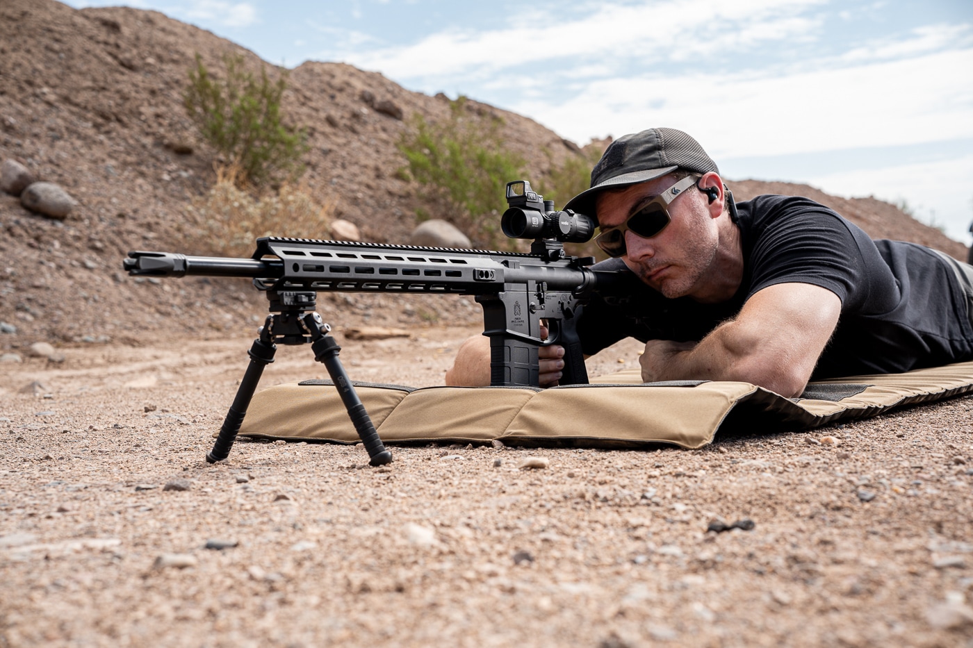 A shooter lies prone on a shooting mat at an outdoor range, aiming the Springfield Armory SAINT Victor 7.62mm rifle downrange. The SAINT Victor 308 review process begins with real-world range testing by an experienced precision shooter. Springfield SAINT Victor 7.62 NATO rifles are evaluated for accuracy using match-grade ammunition. Precision semi-automatic rifles chambered in 308 Winchester perform well when tested from a stable prone position. The AR-10 platform offers shooters a modular, ergonomic option for long-range engagements.