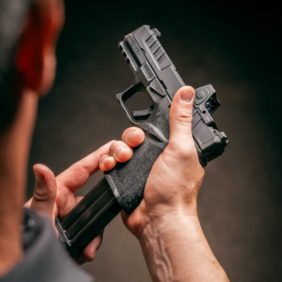 inserting a fresh magazine into a Springfield Echelon pistol during a malfunction drill
