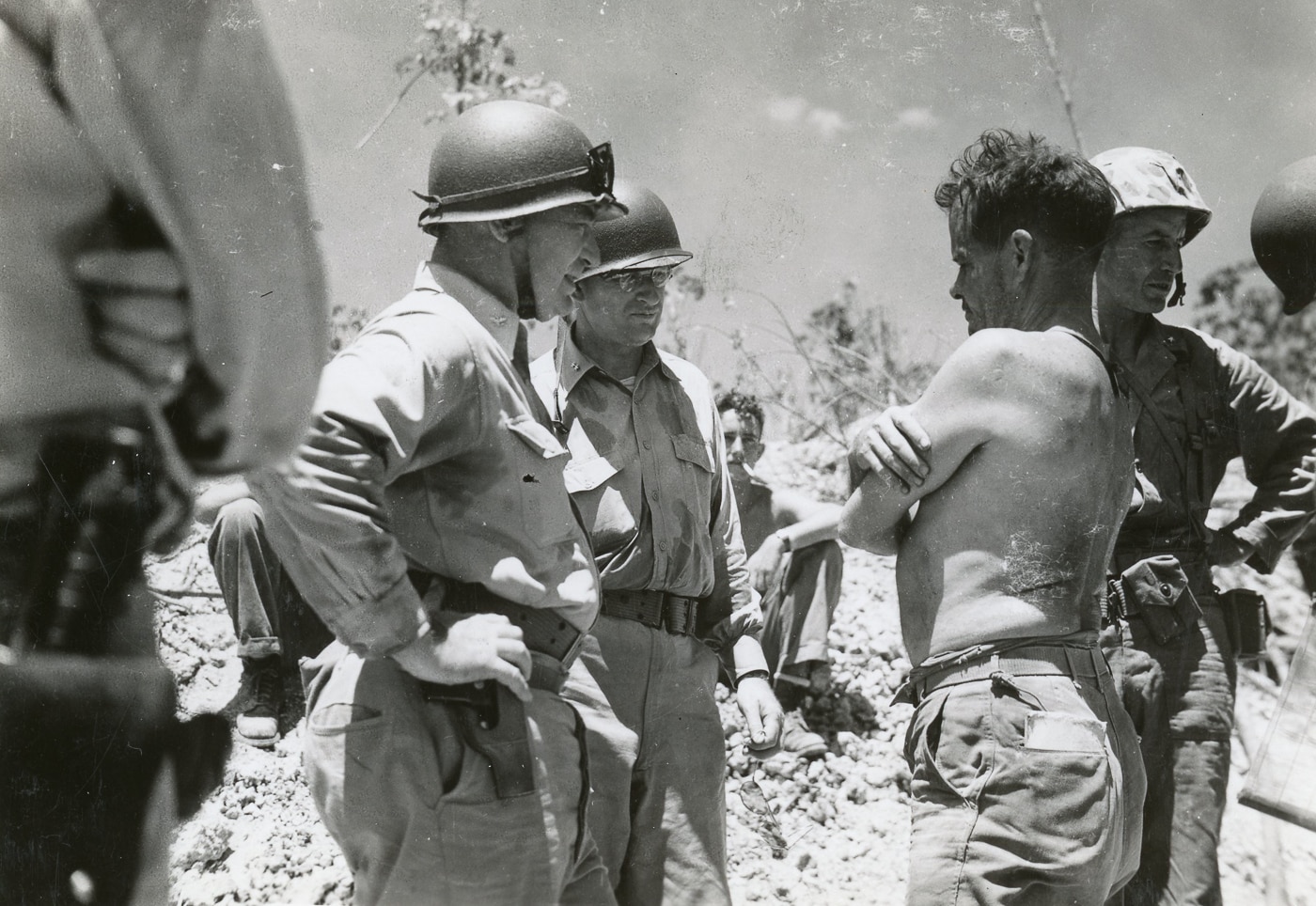 shirtless Chesty Puller talks to commanding officers during Battle of Peleliu