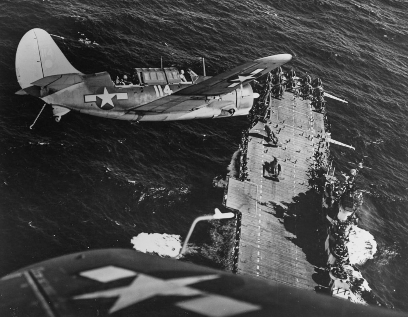 Curtiss SB2C Helldiver flies over USS Hornet CV-12 after strikes on Japanese ships in the China Sea 1945
