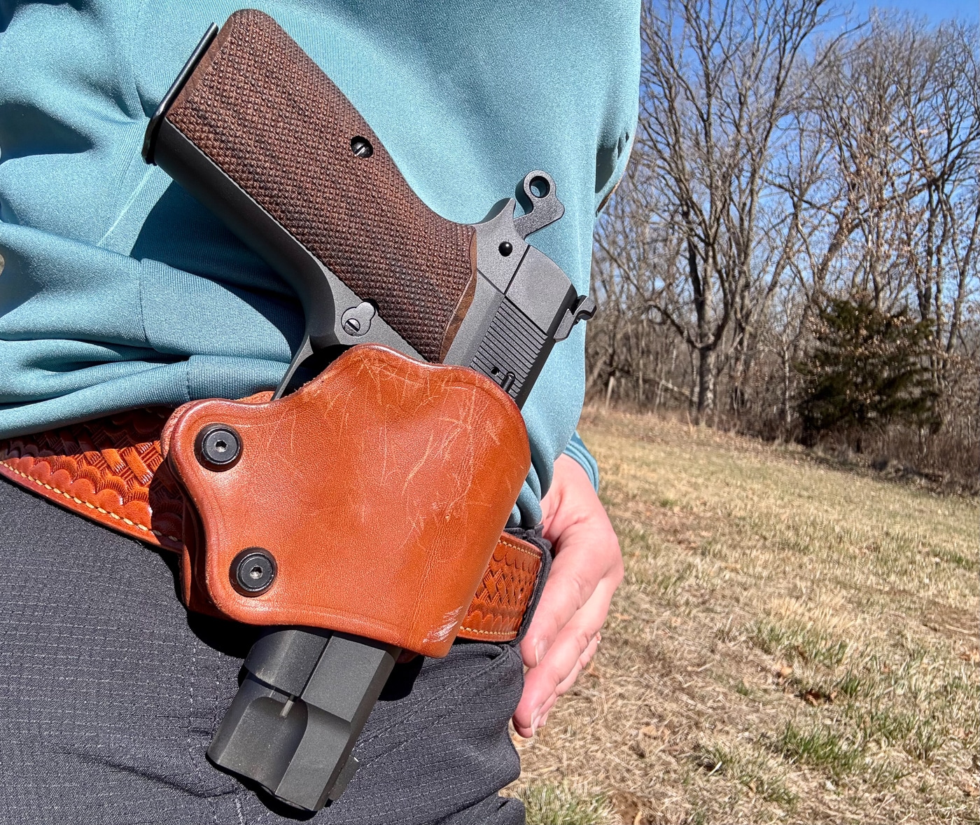 Julie Golob carrying Springfield SA-35 4 compact in leather belt holster