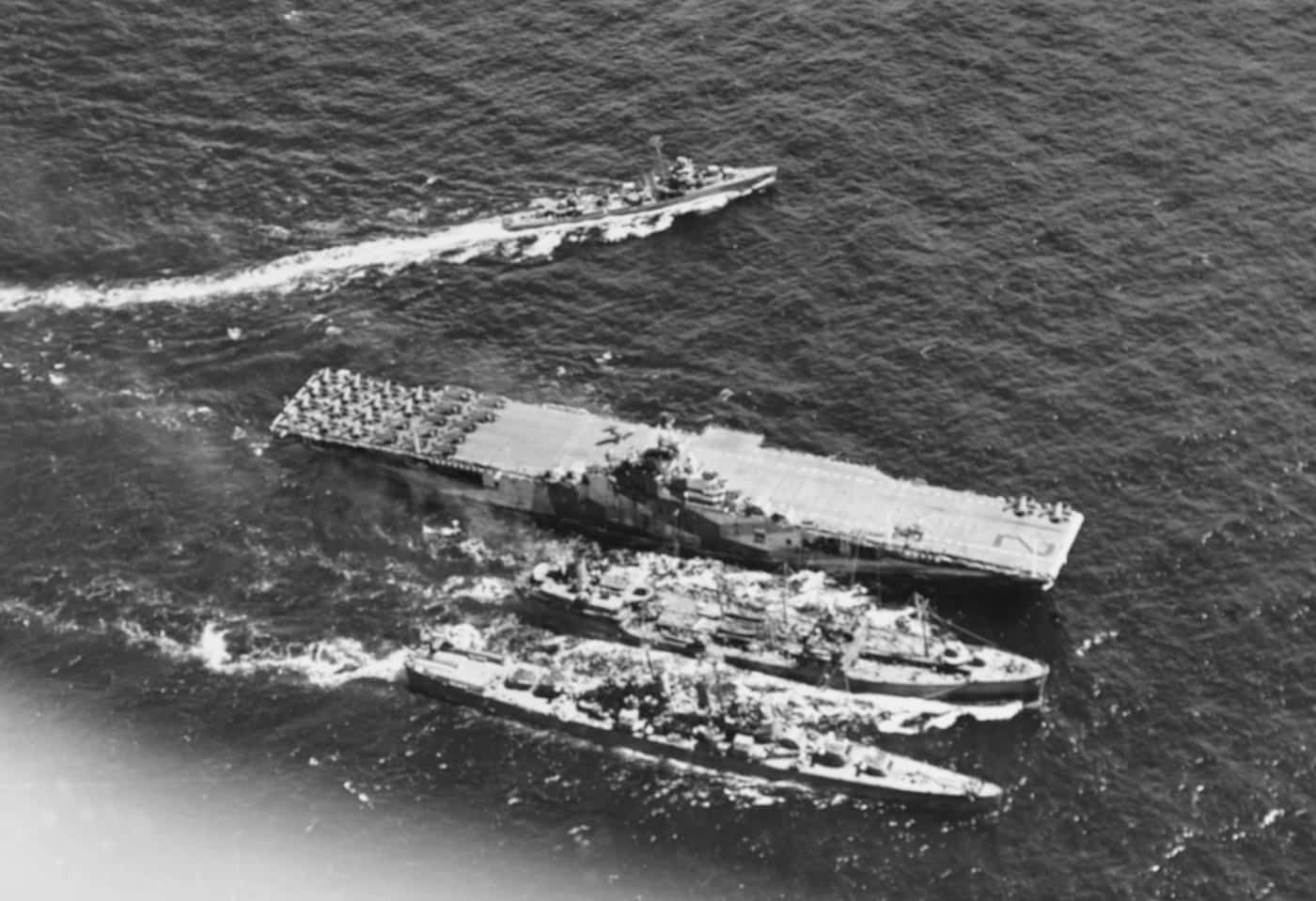 USS Hornet CV-12 and unknown light cruiser refuel while underway prior to air strikes on Chichi Jima August 1944