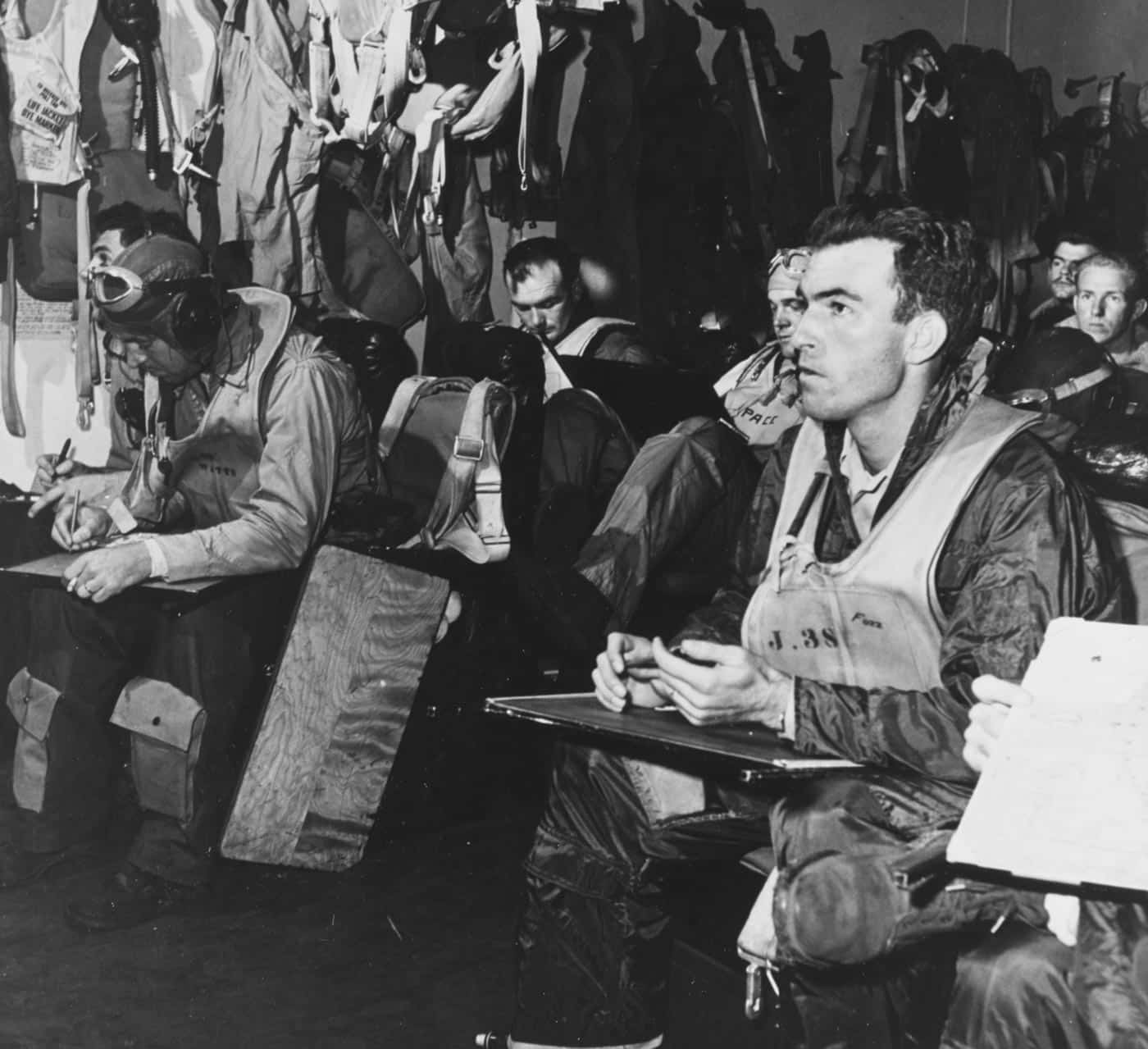 USS Hornet CV-12 pilots brief in ready room during combat operations in China Sea January 1945